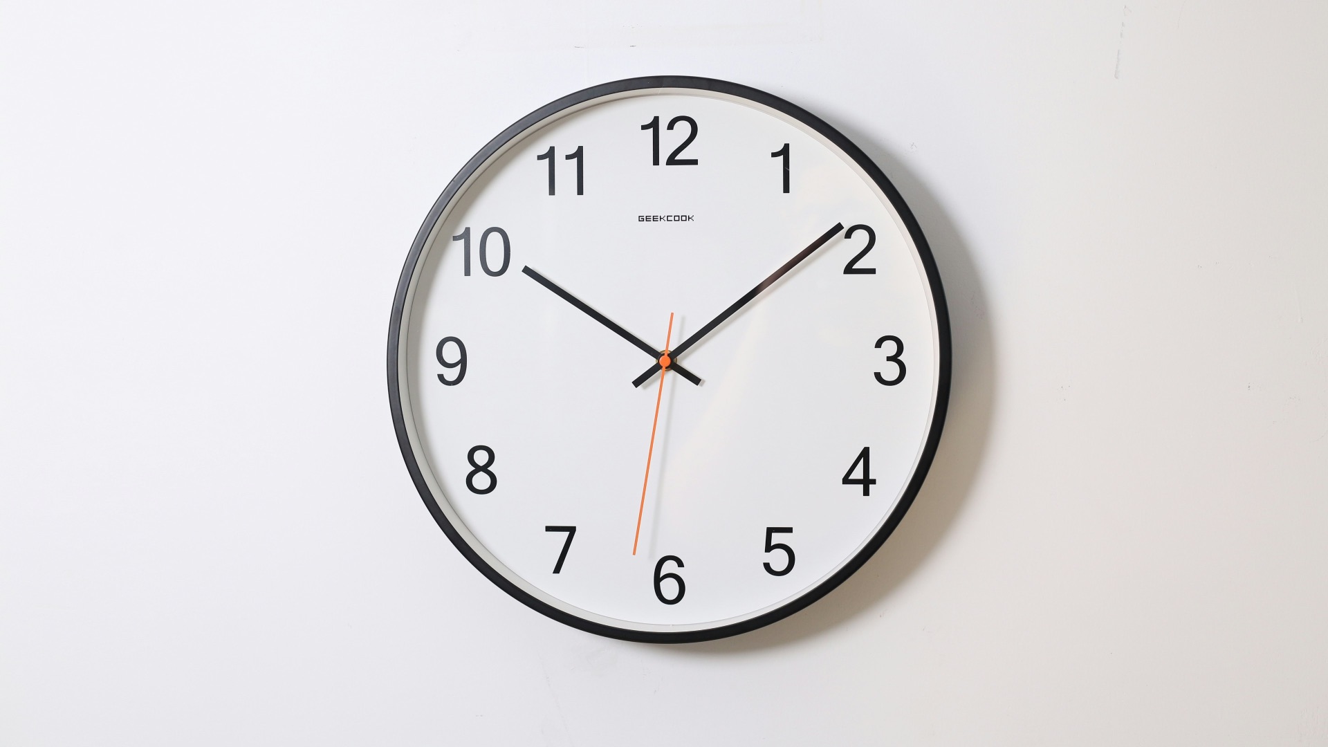 round analog wall clock pointing at 10:09
