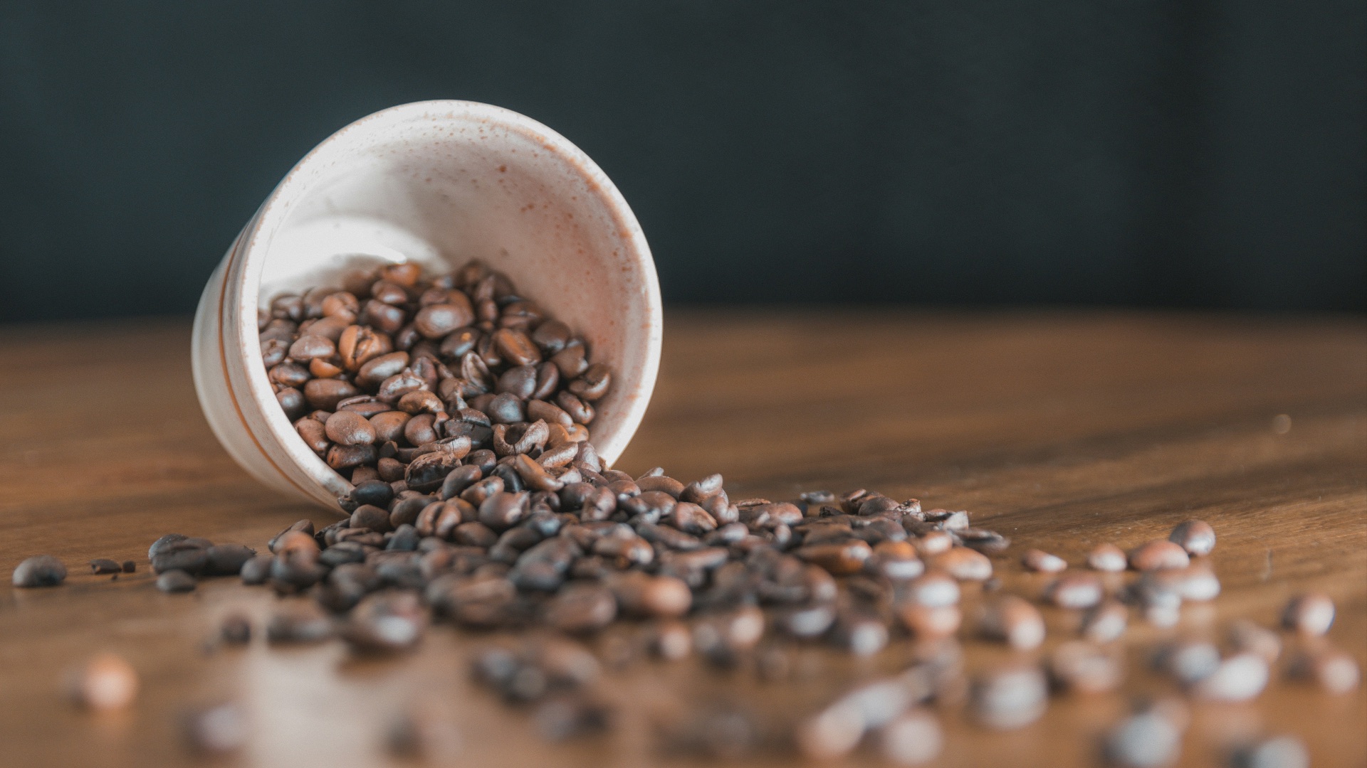 a white egg in a bowl of coffee beans