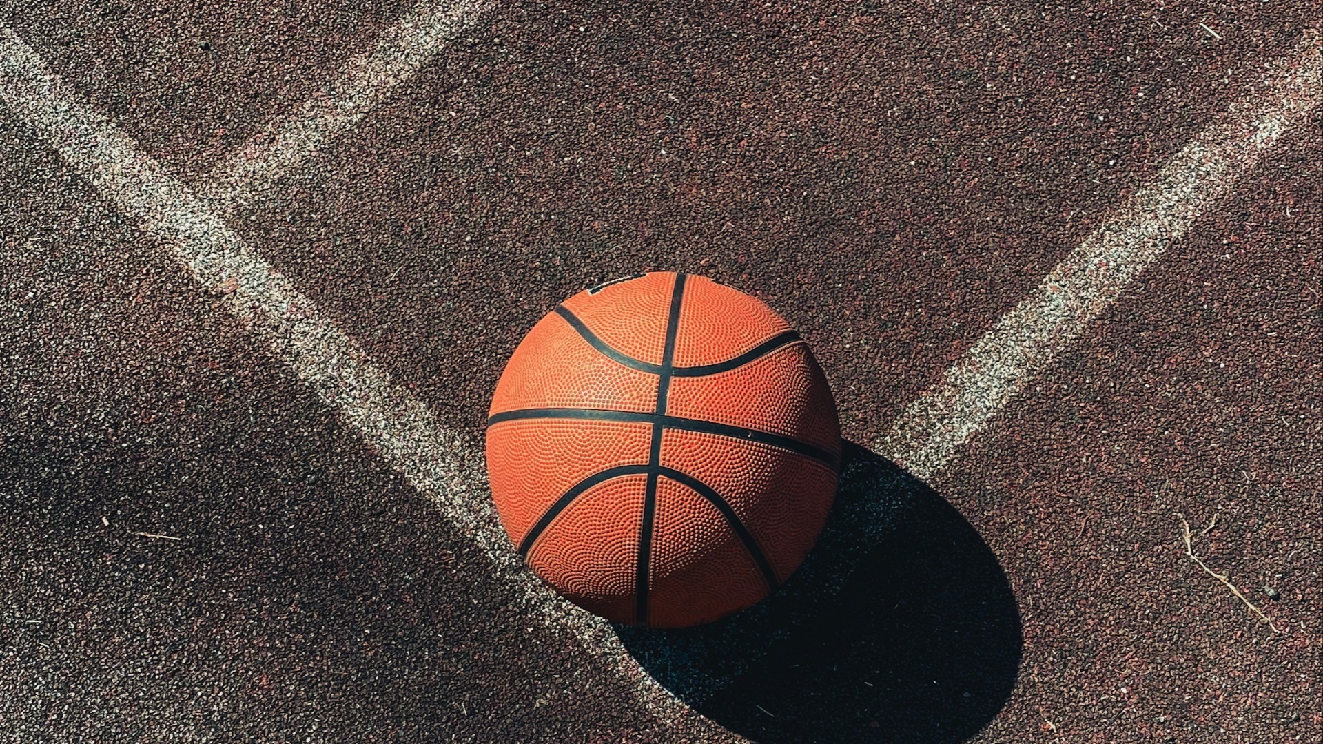 brown basketball on gray concrete floor