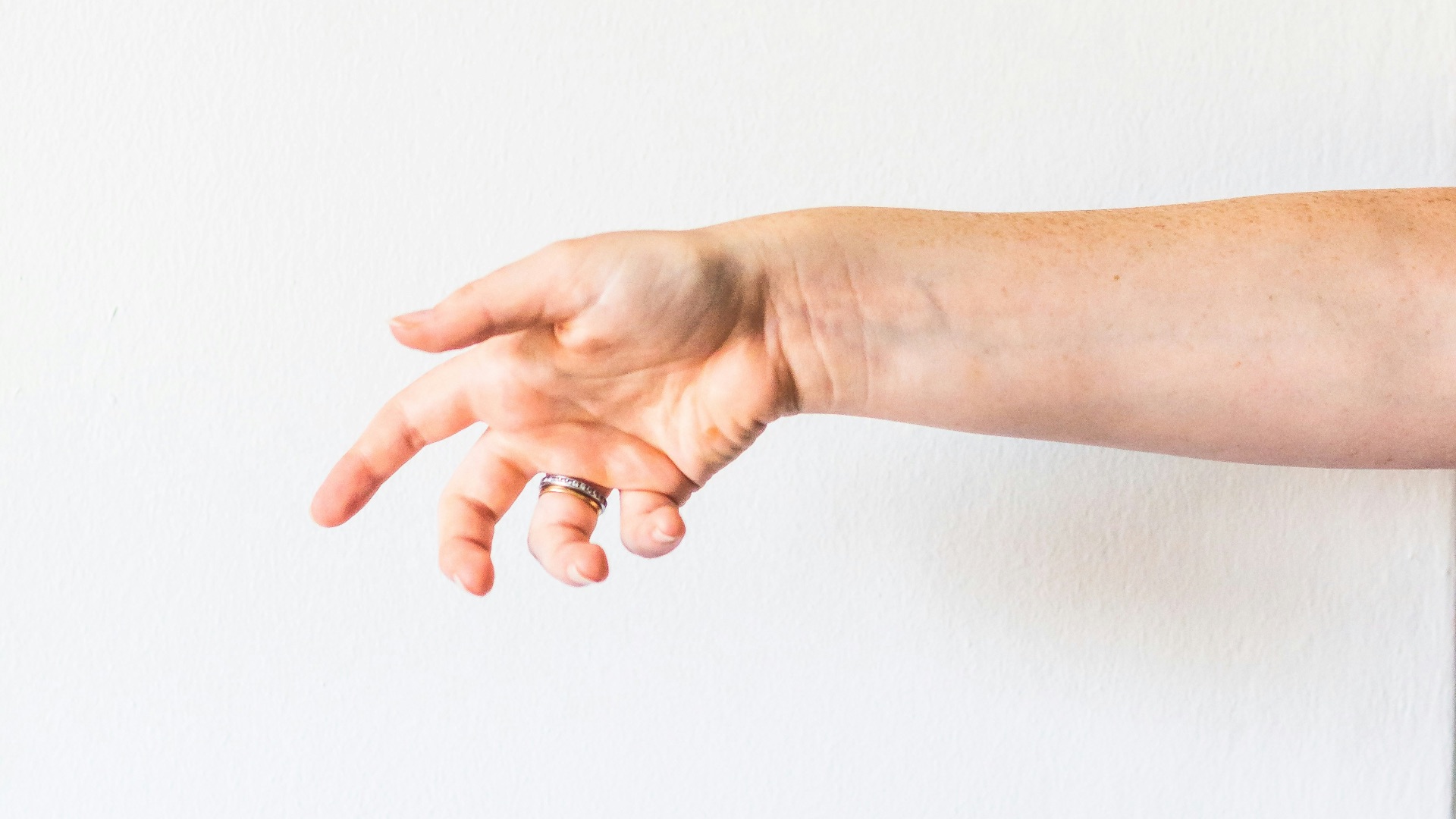 persons hand on white surface