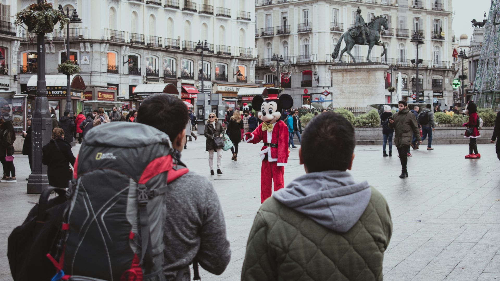 man and woman standing near white concrete building