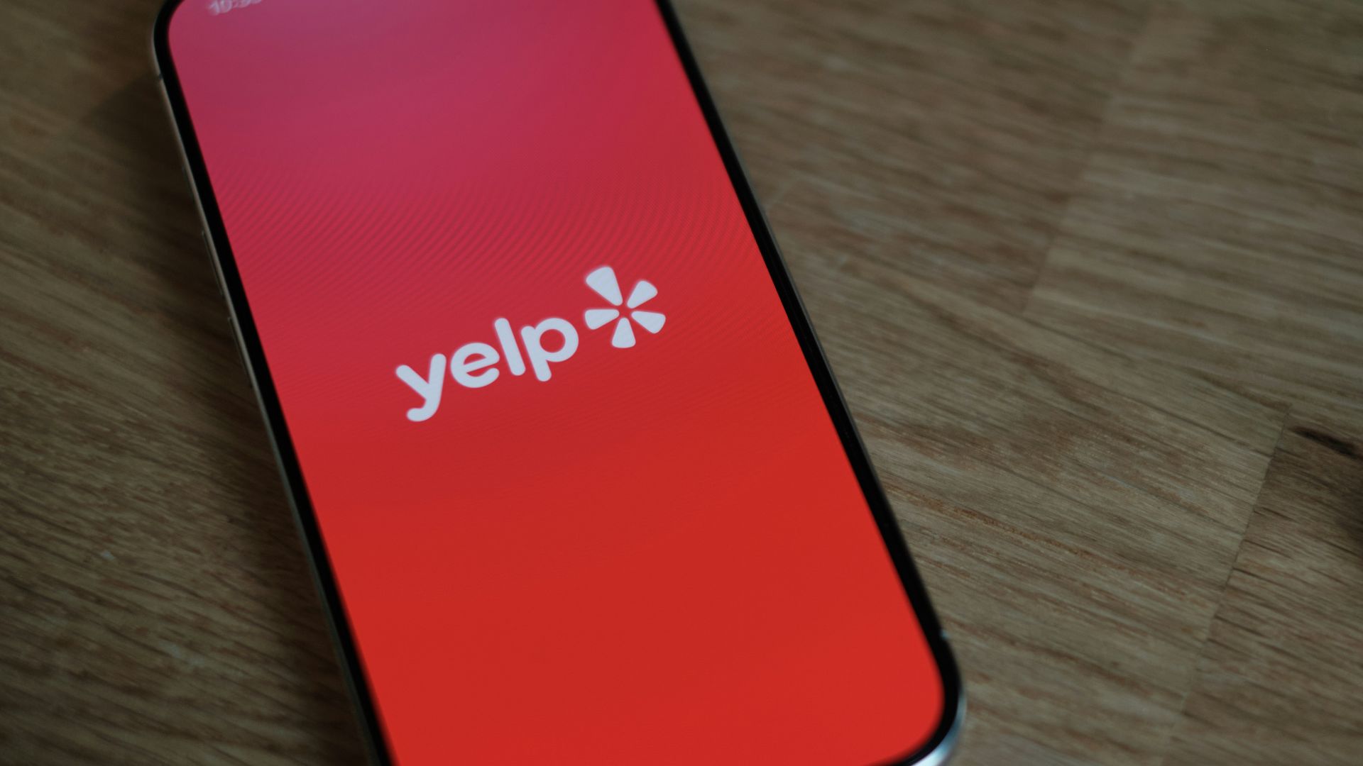 A cell phone sitting on top of a wooden table