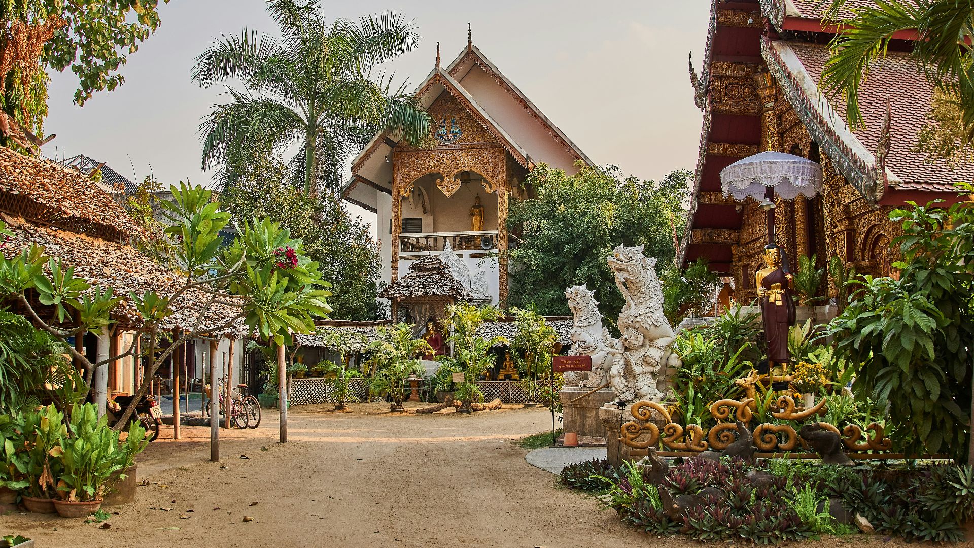 brown and white concrete house surrounded by green trees during daytime