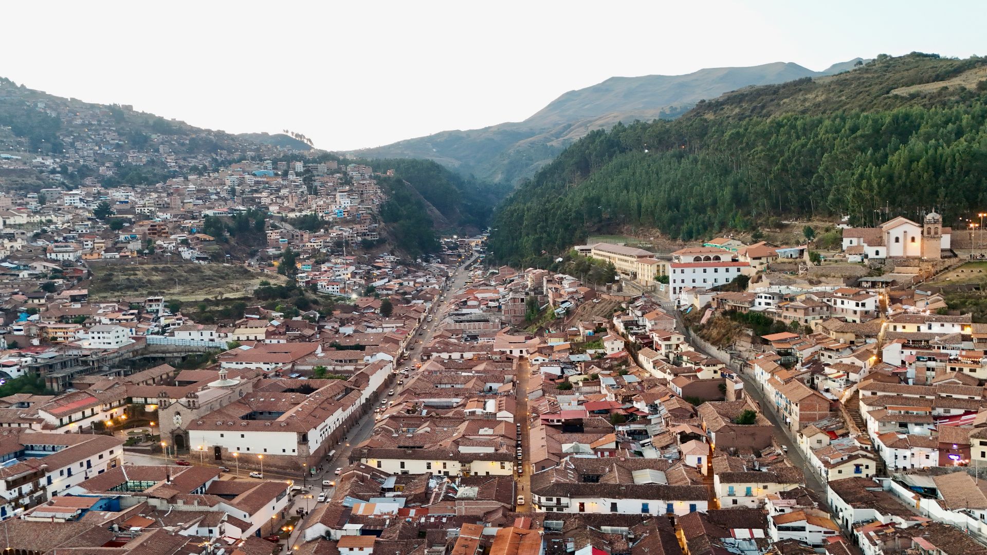 An aerial view of a city with mountains in the background