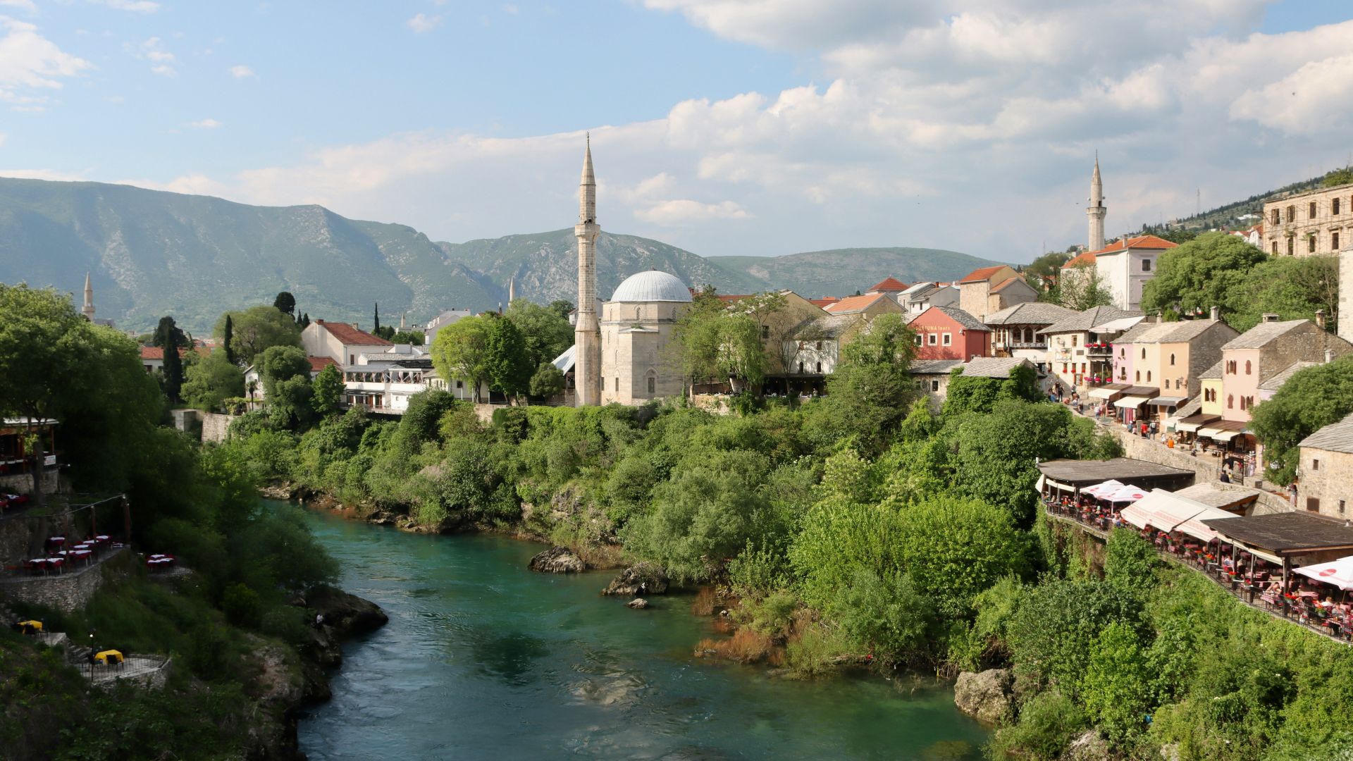 a river running through a lush green hillside