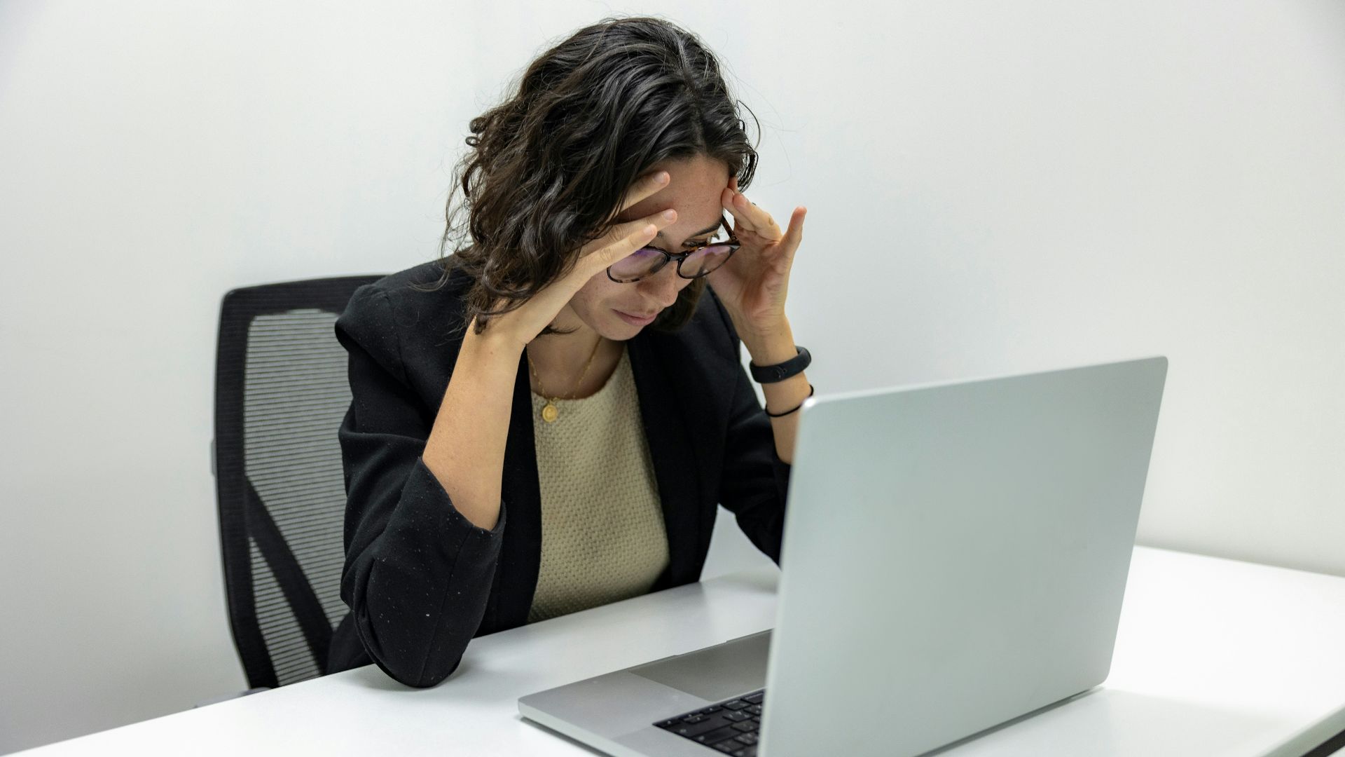 a woman sitting in front of a laptop computer