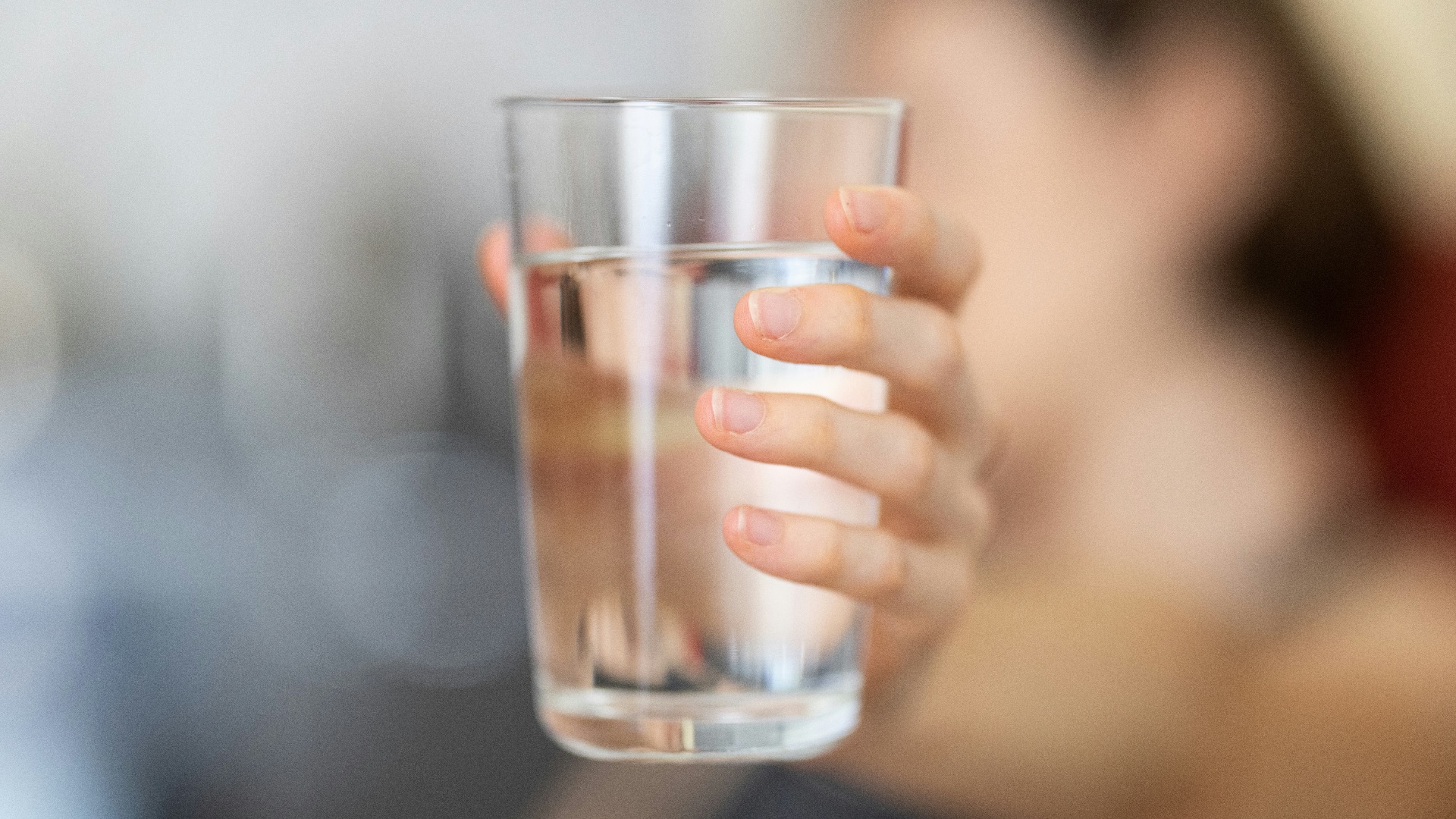 person holding clear drinking glass
