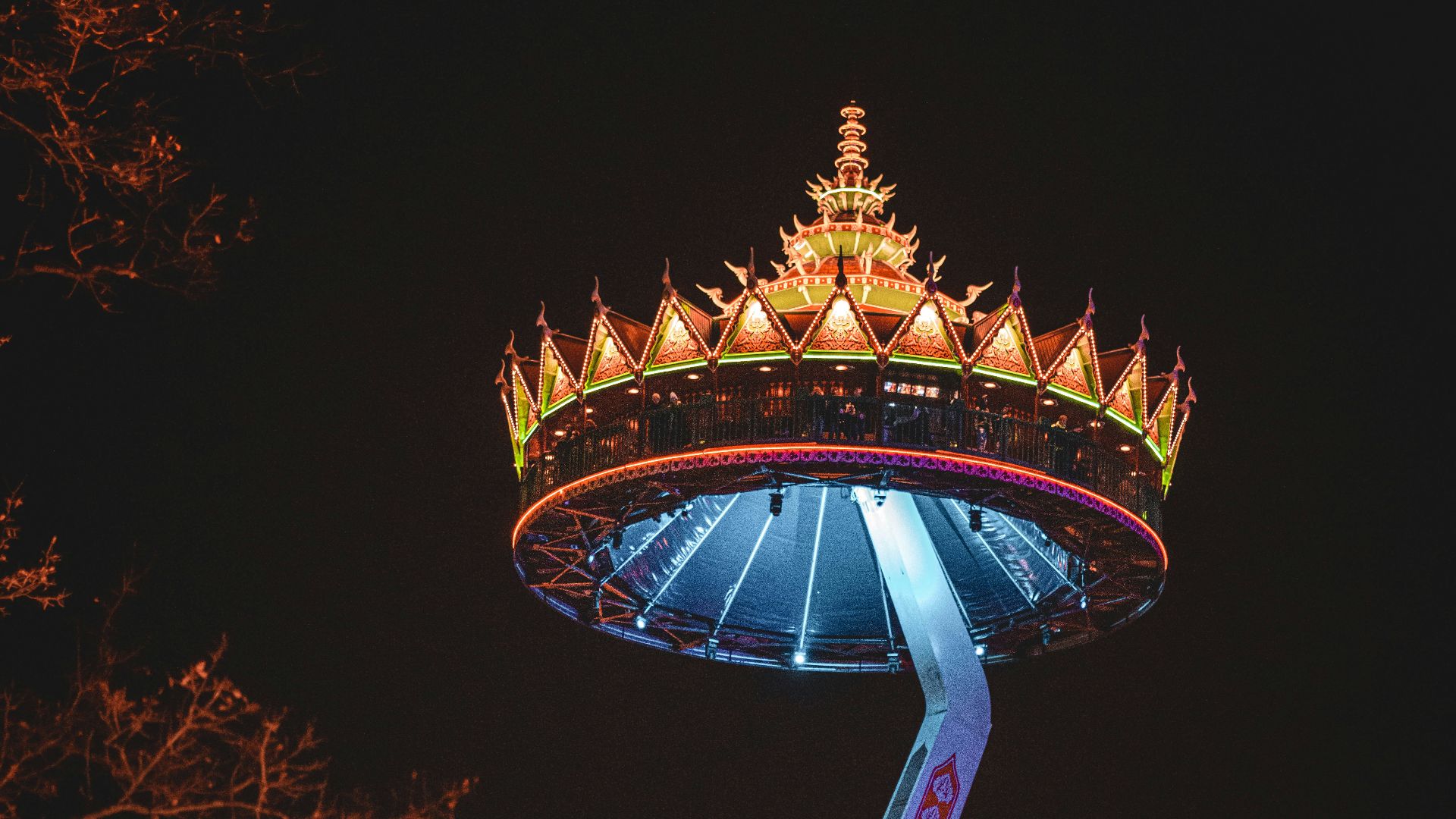 a carnival ride lit up at night in the dark