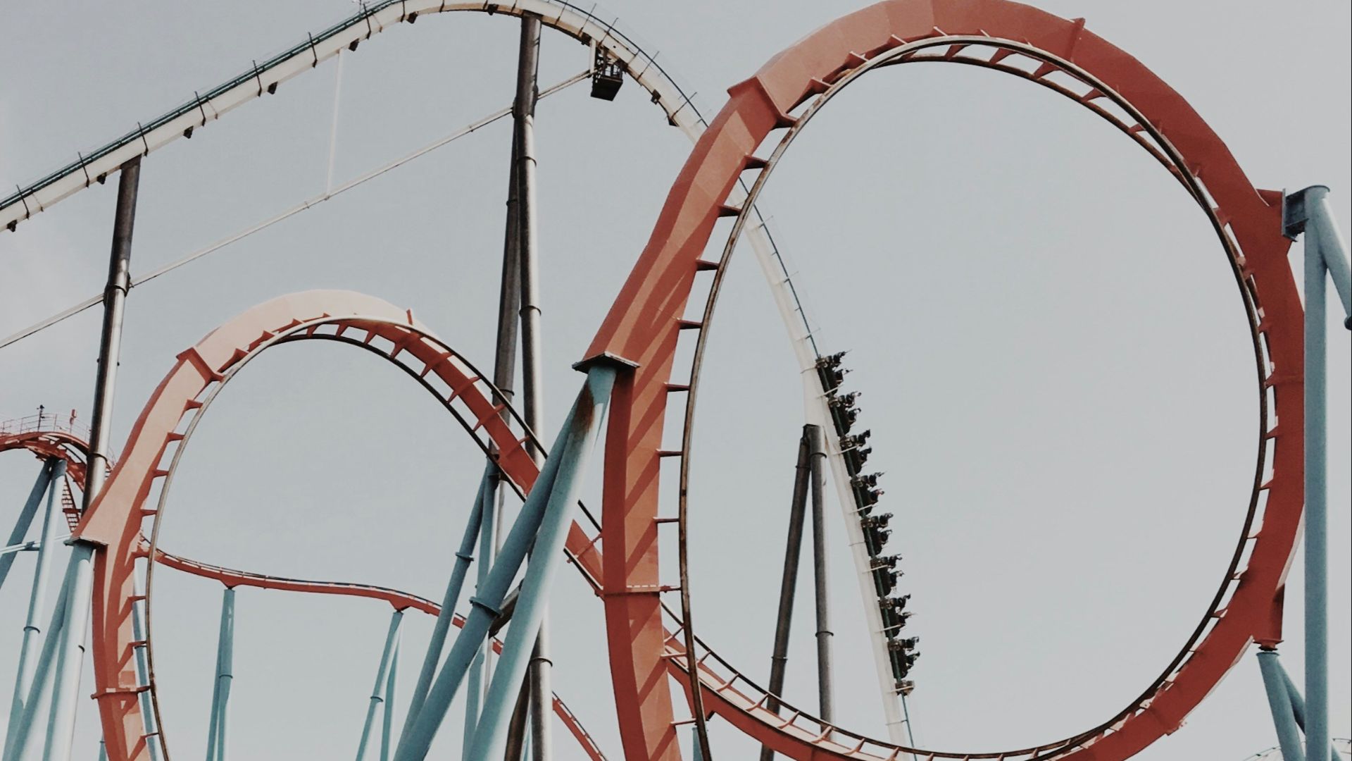 people riding roller coaster during day