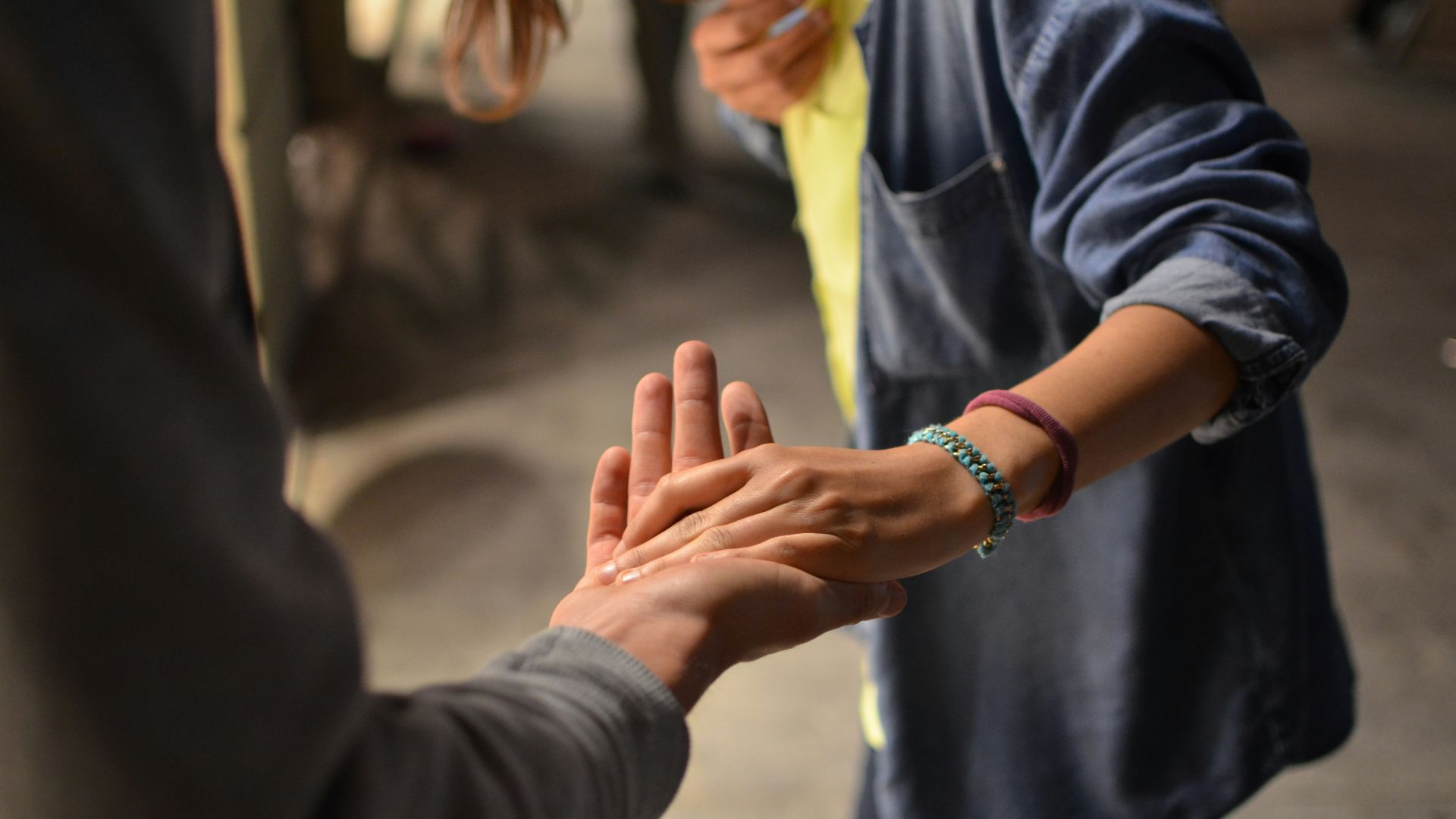 man and woman holding hands on street