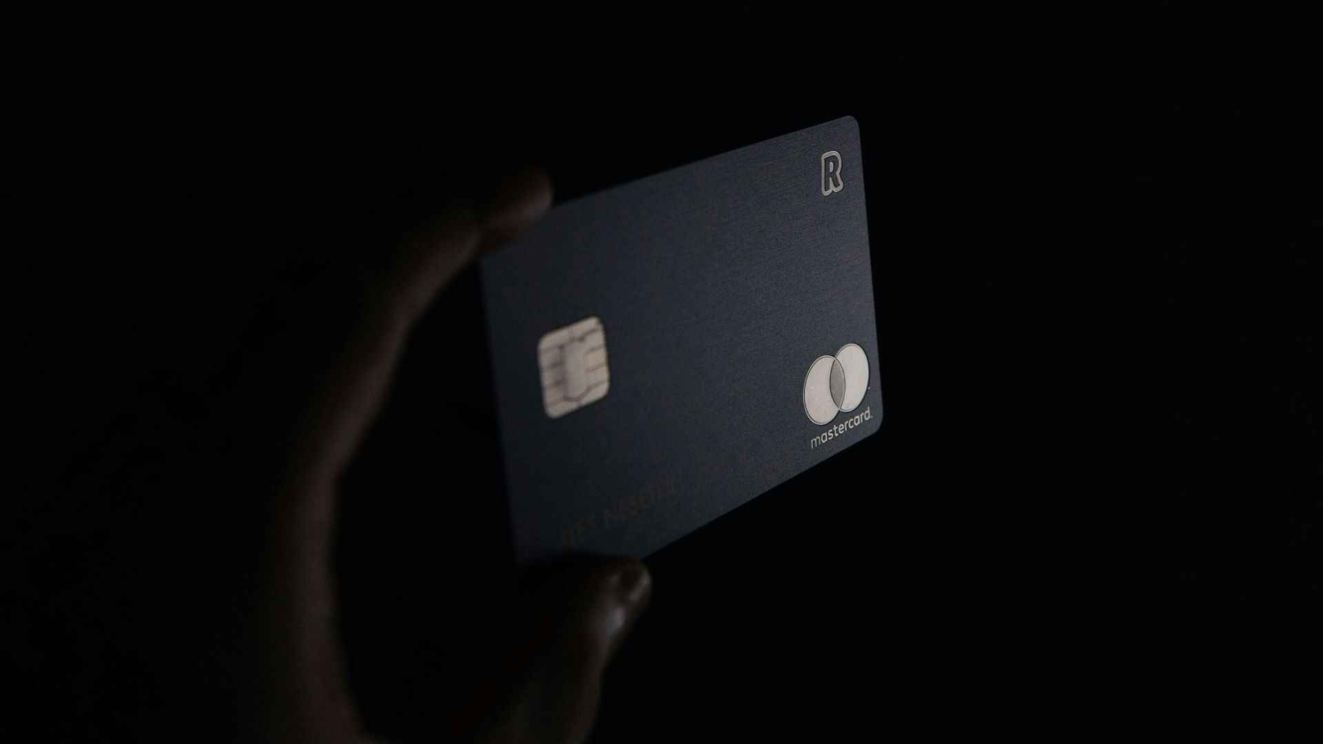 person holding black card