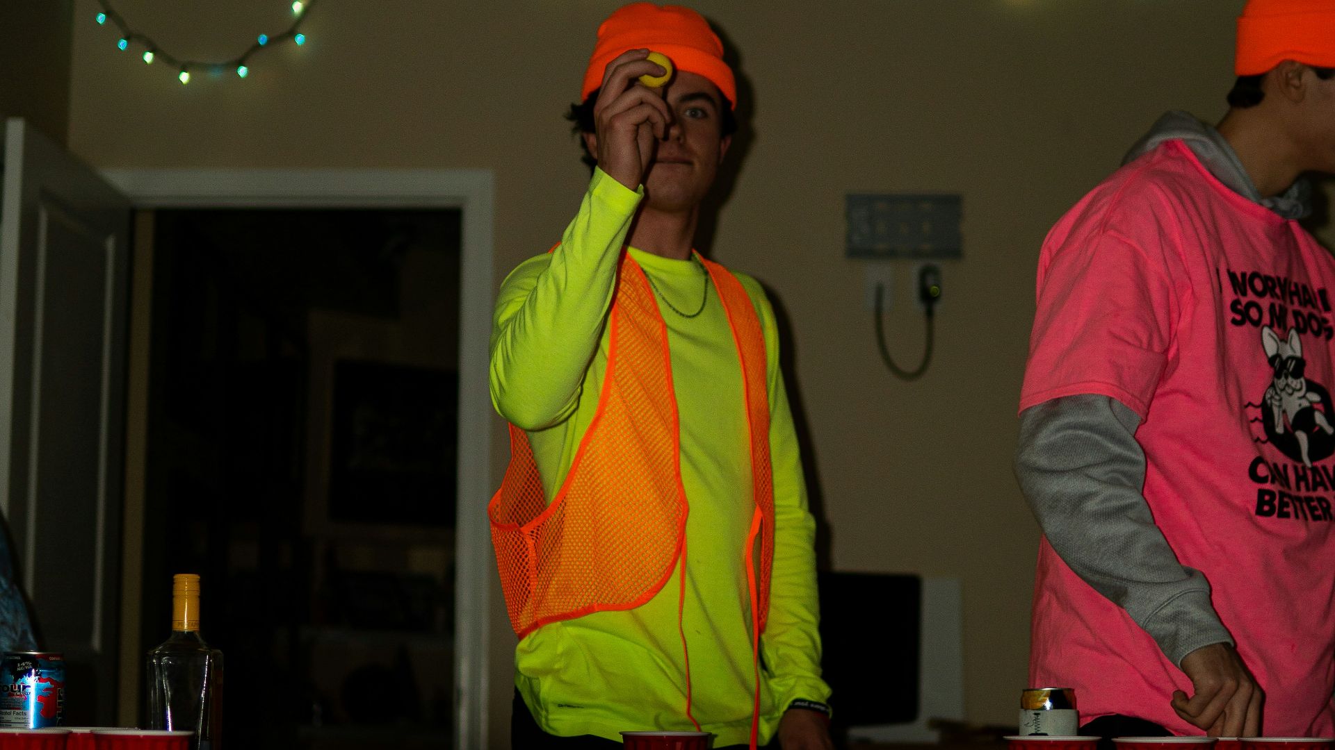 man in pink crew neck t-shirt standing beside man in red crew neck t-shirt