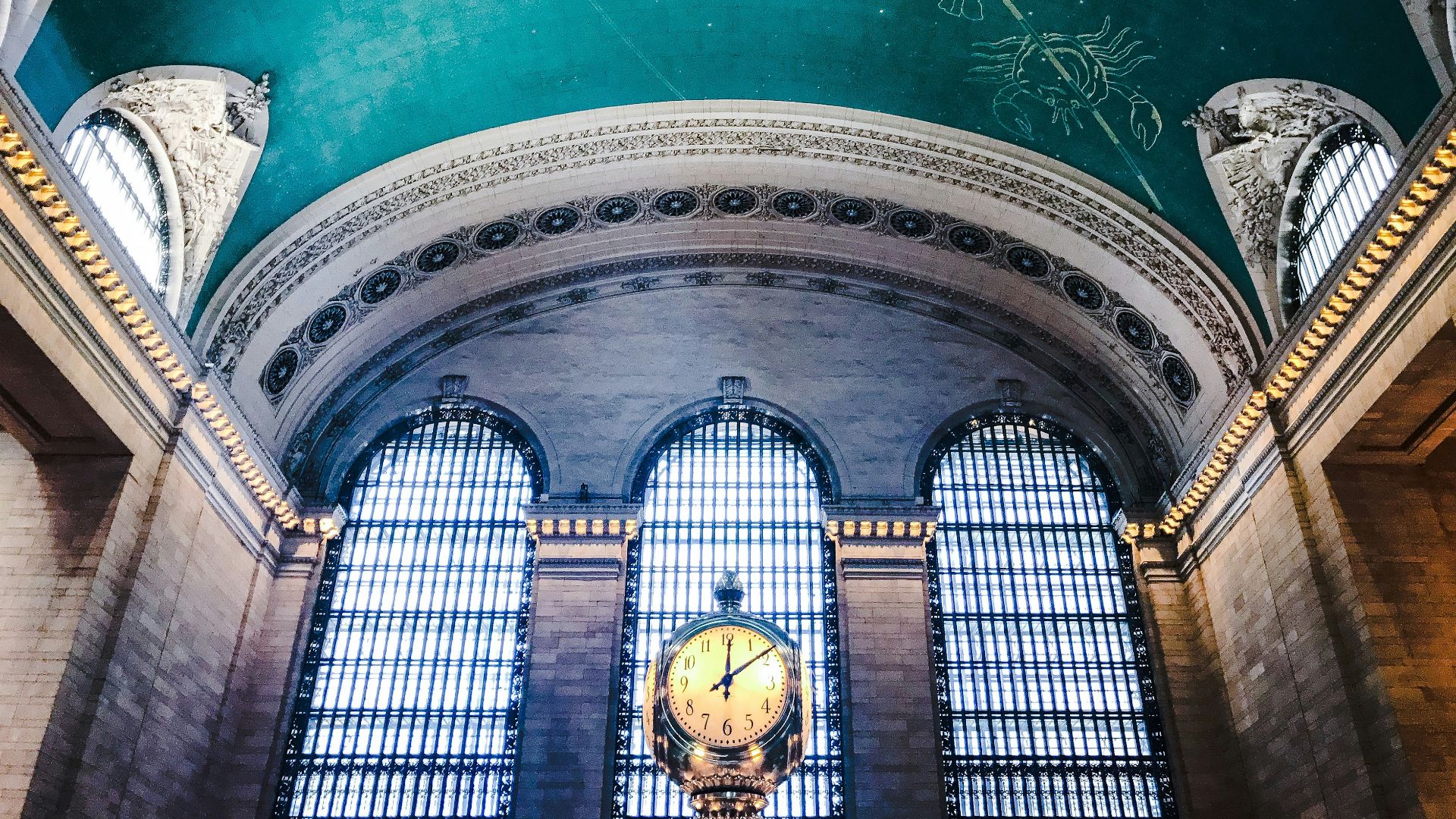 low angle of round biege clock near wall