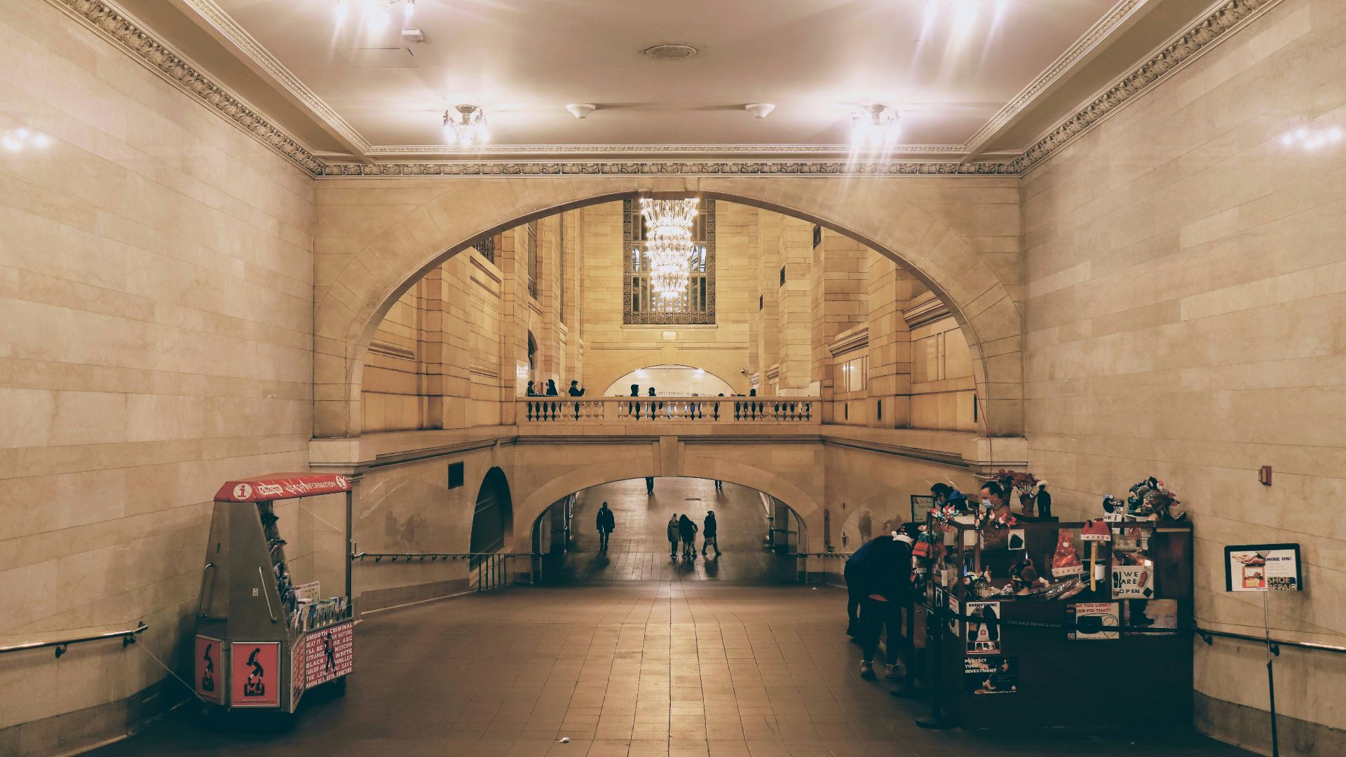 a train station with people walking around it