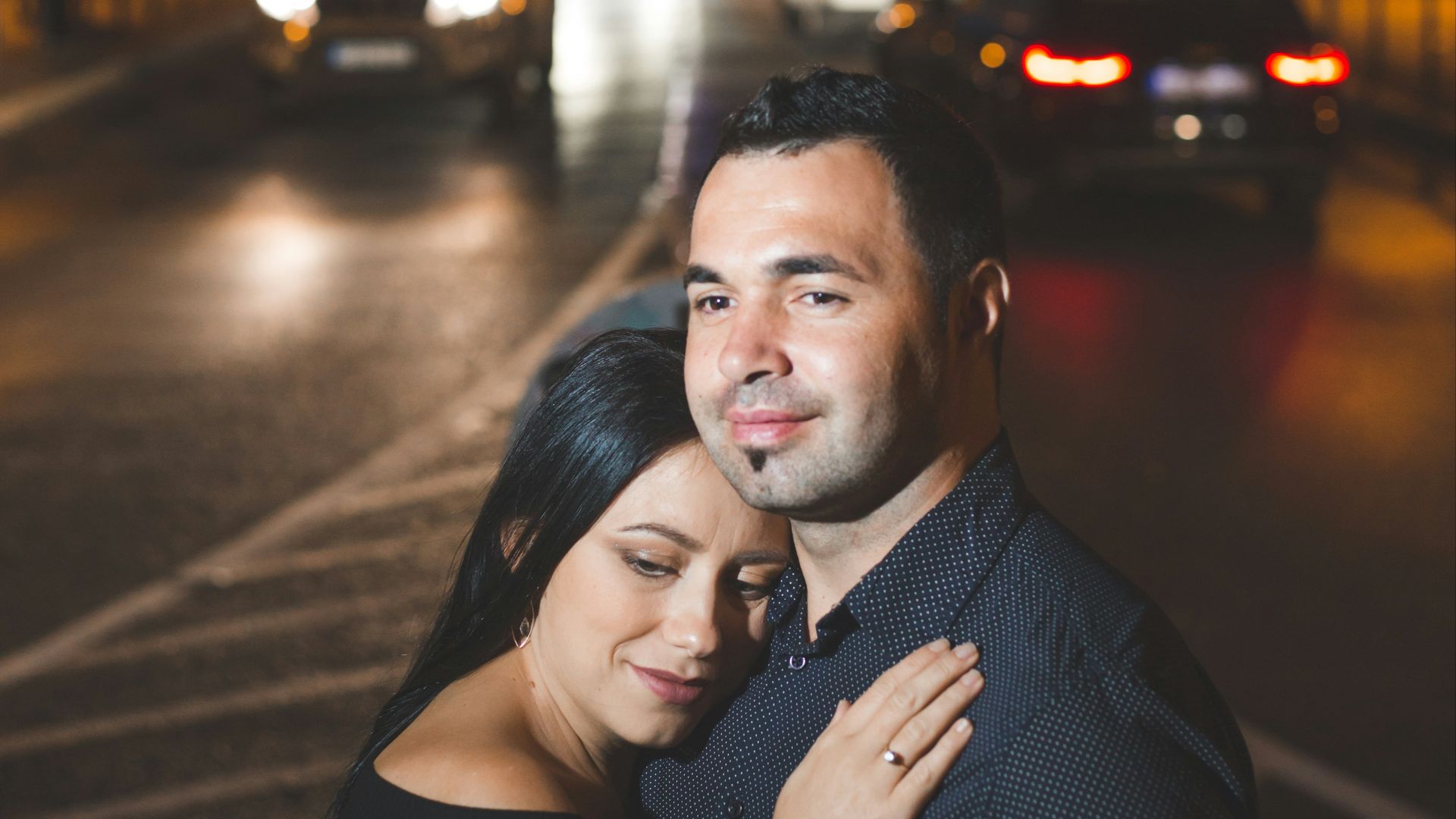 a man and woman hugging in front of the eiffel tower