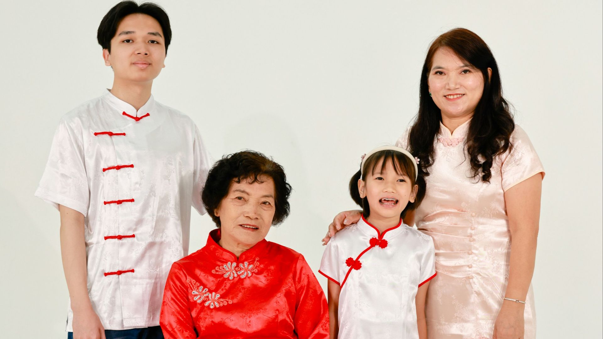 A multi-generational family in traditional chinese attire.