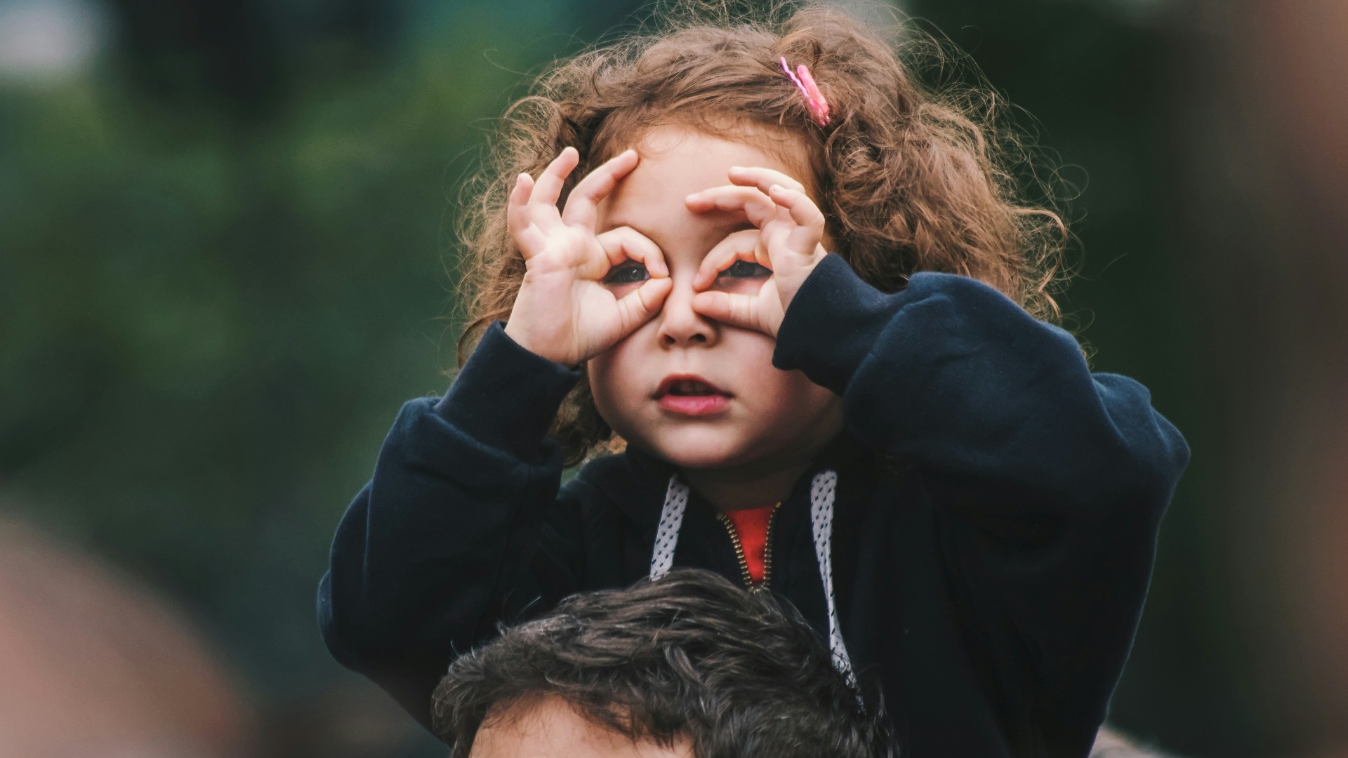 girl making hand gesture on her face