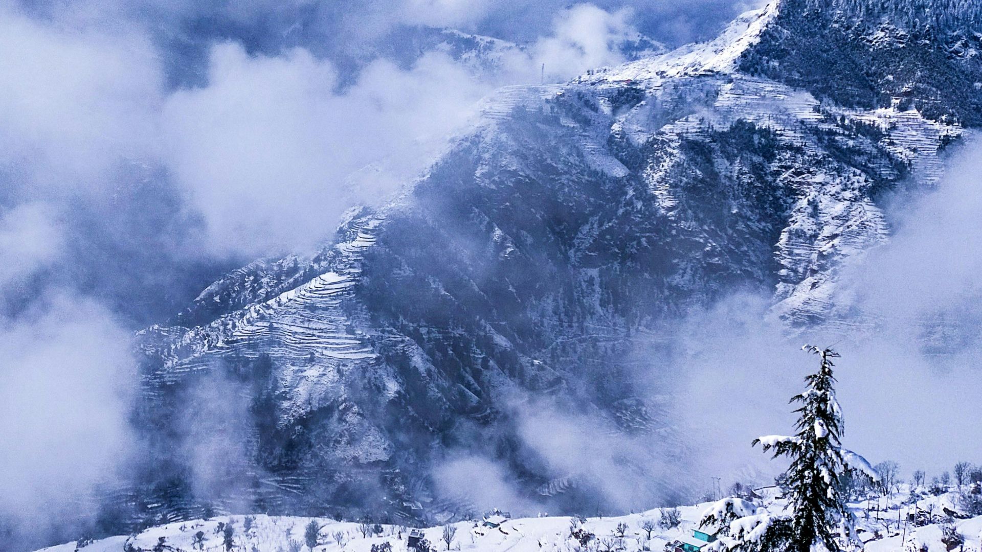 snow covered mountain under cloudy sky during daytime