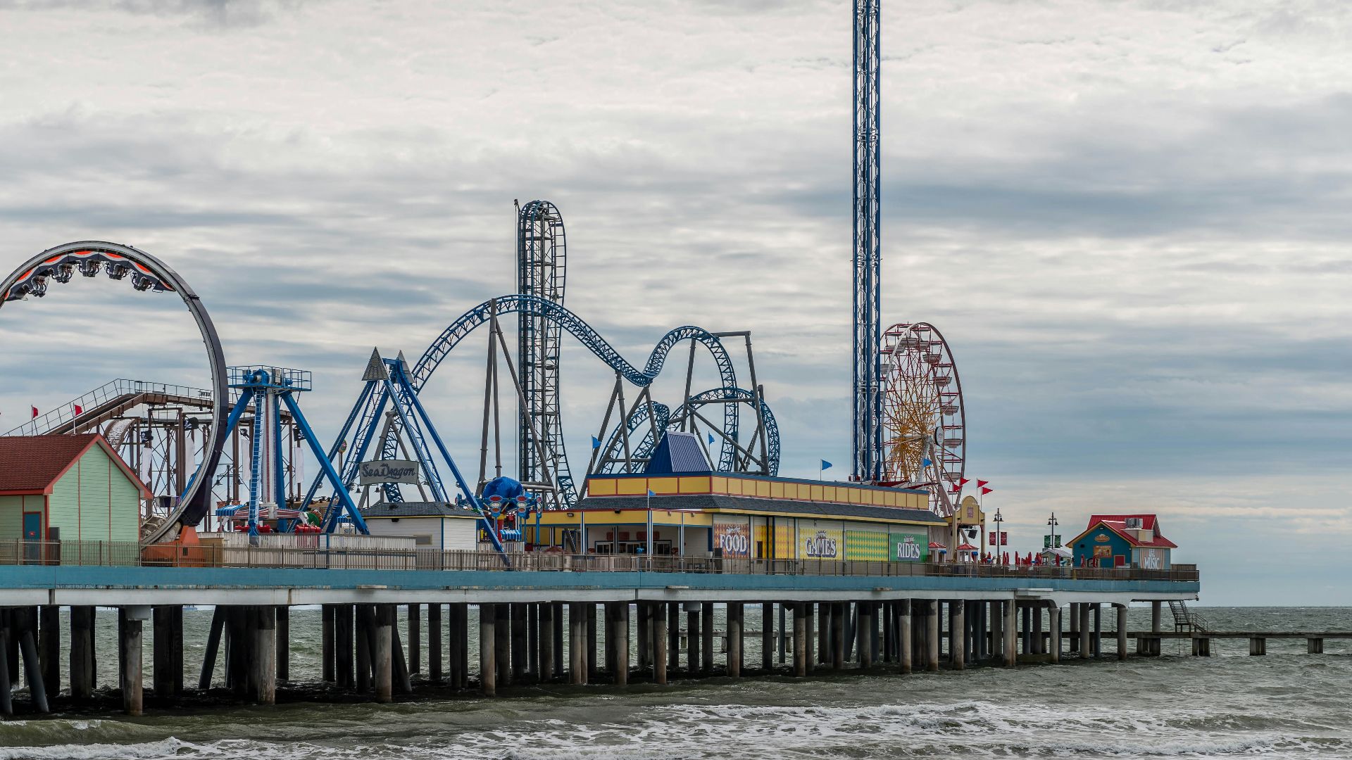 blue and white ferris wheel near body of water during daytime