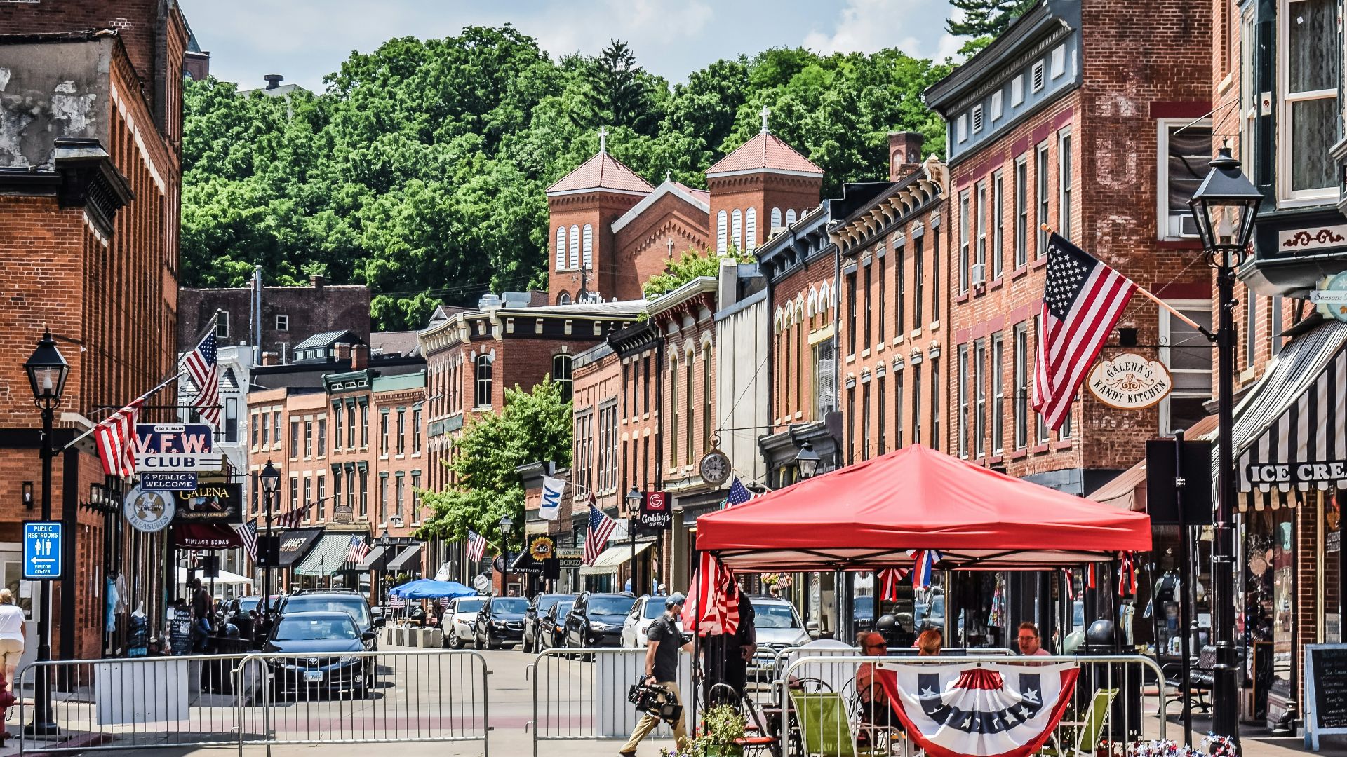 a street scene with a red tent in the middle of the street