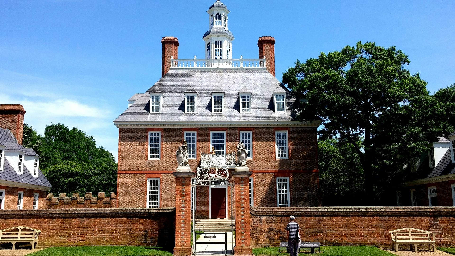 man standing in front of 3-storey house