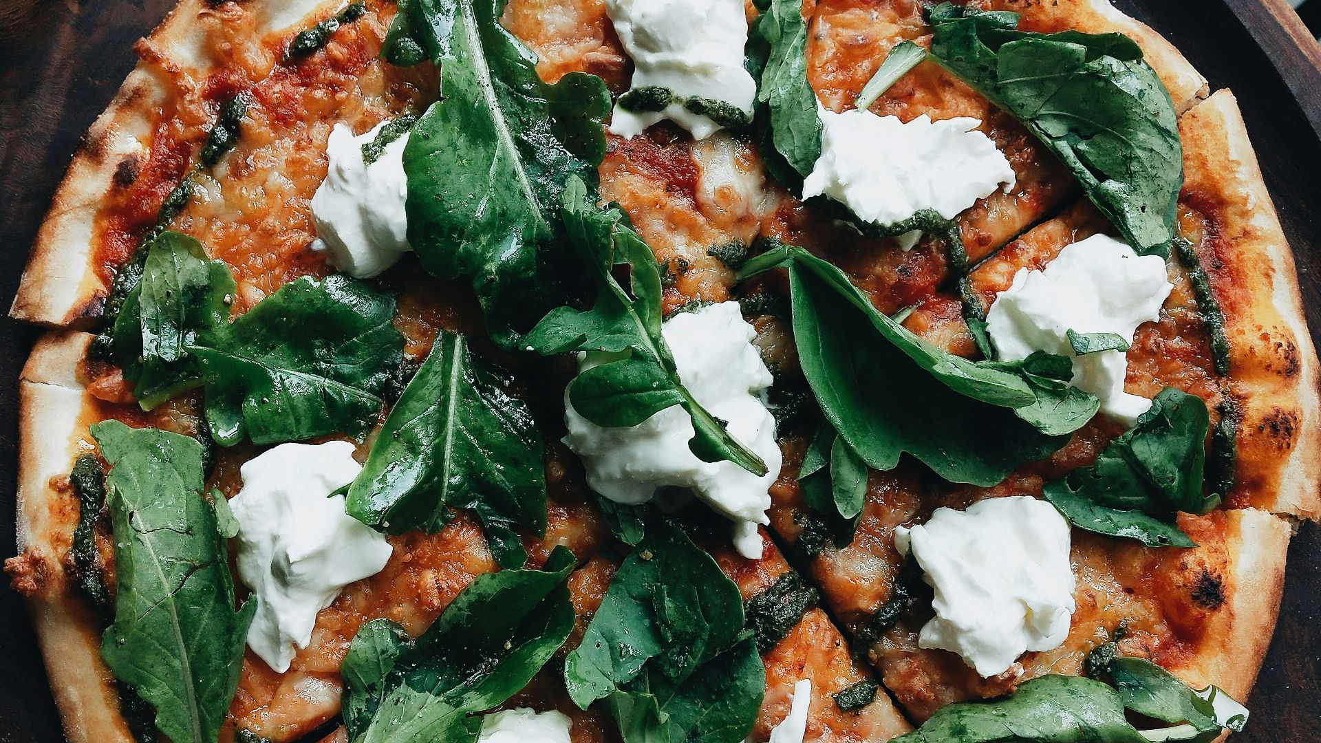 pizza with green leaves on top