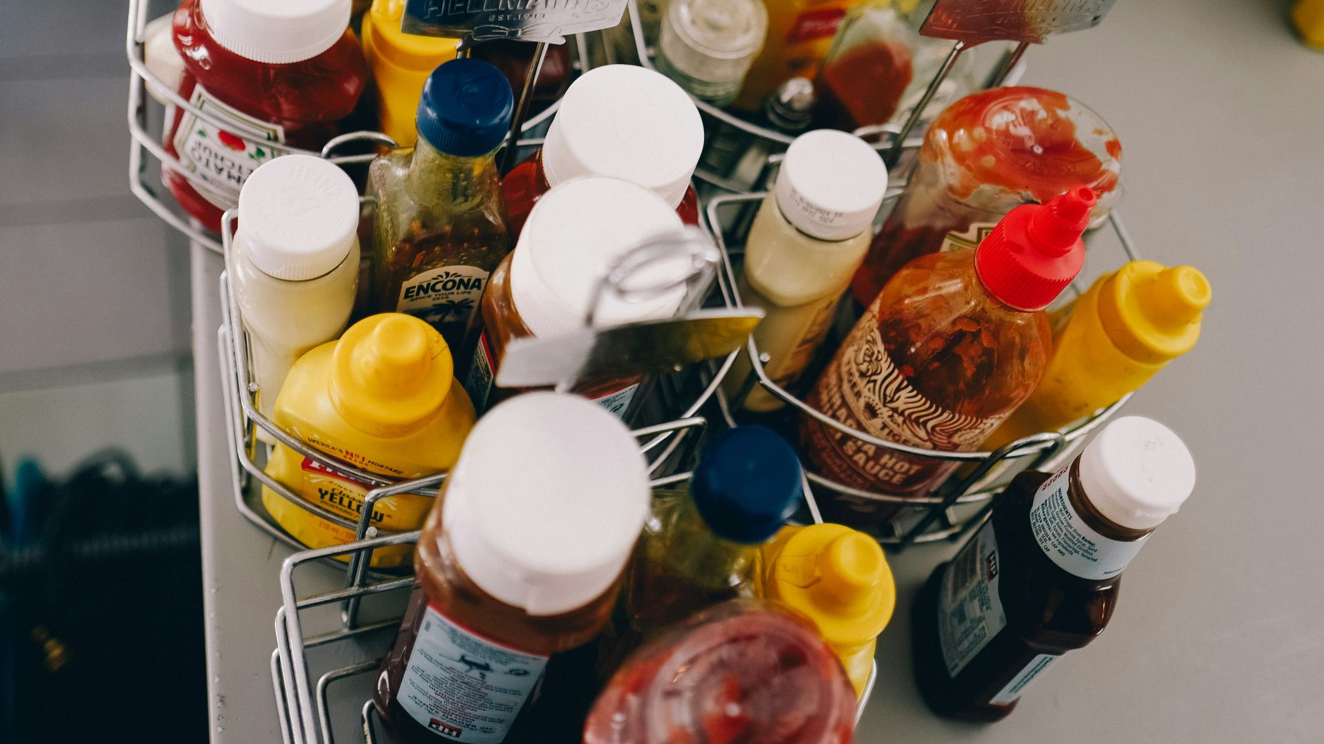 a metal basket filled with lots of condiments