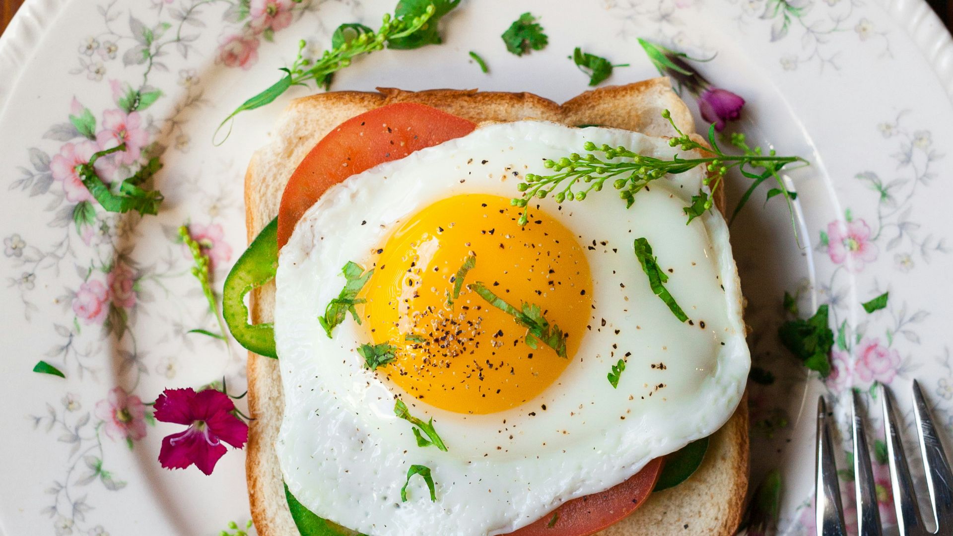 sunny-side up egg with bread beside fork
