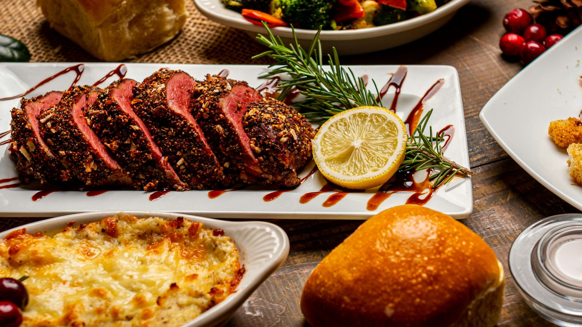 bread on white ceramic plate beside sliced bread on table