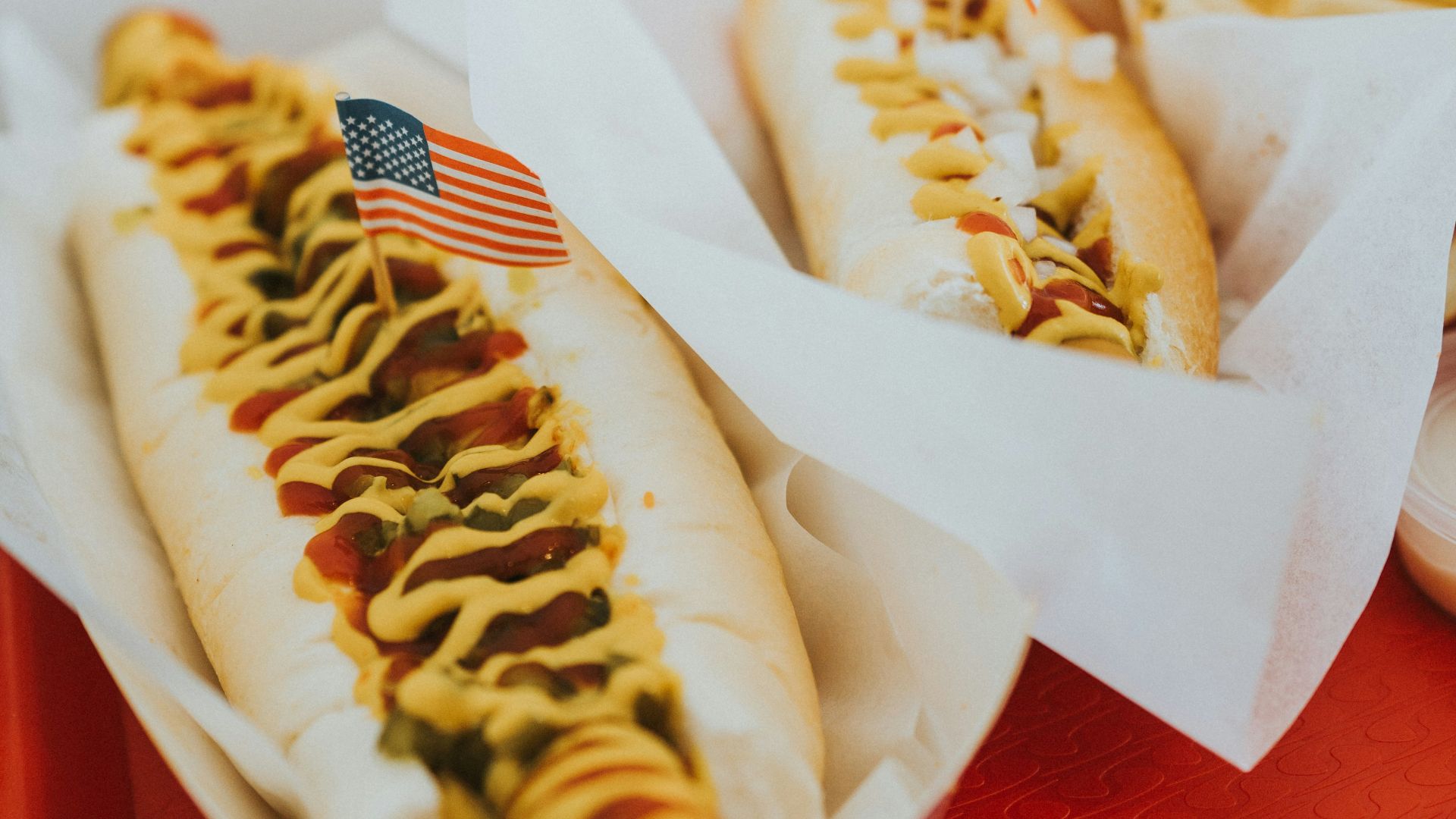 closeup photo of two hotdogs on tray