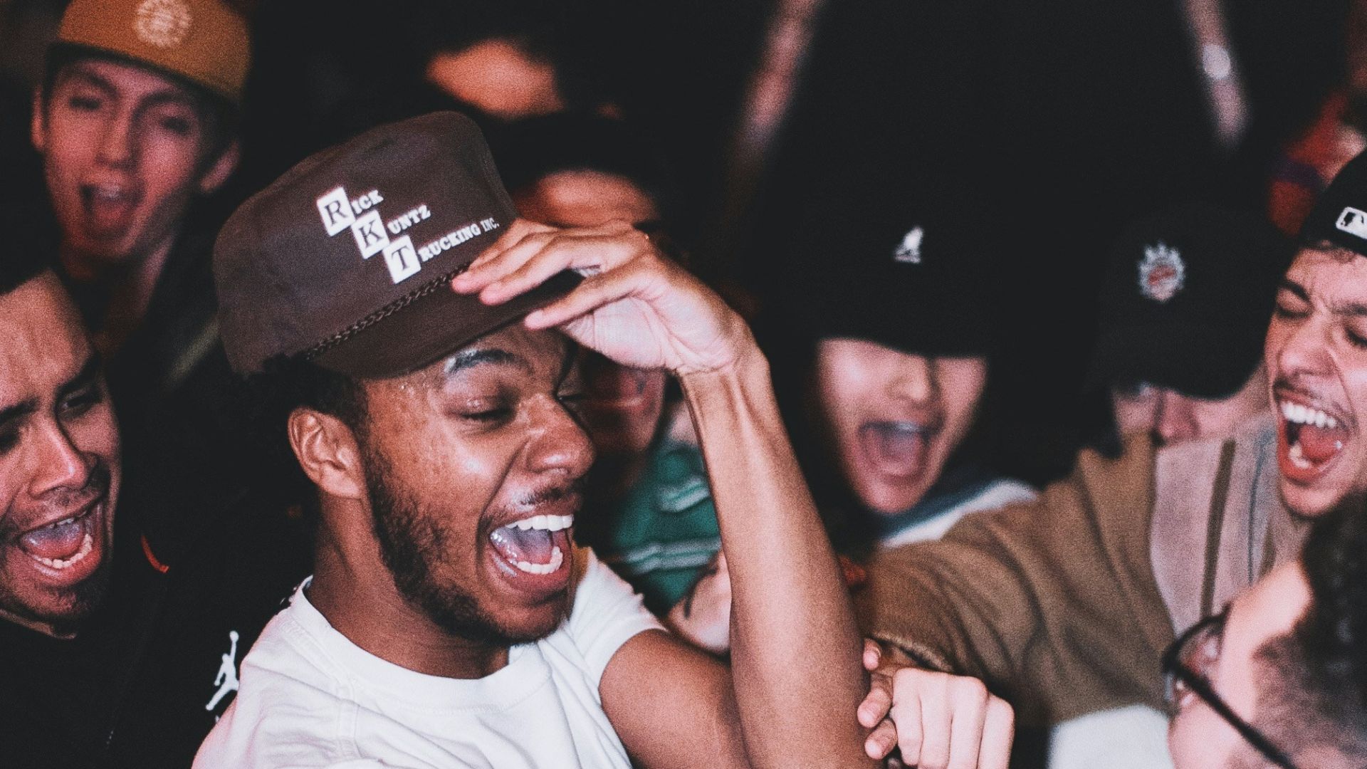 man in white crew neck t-shirt wearing black cap