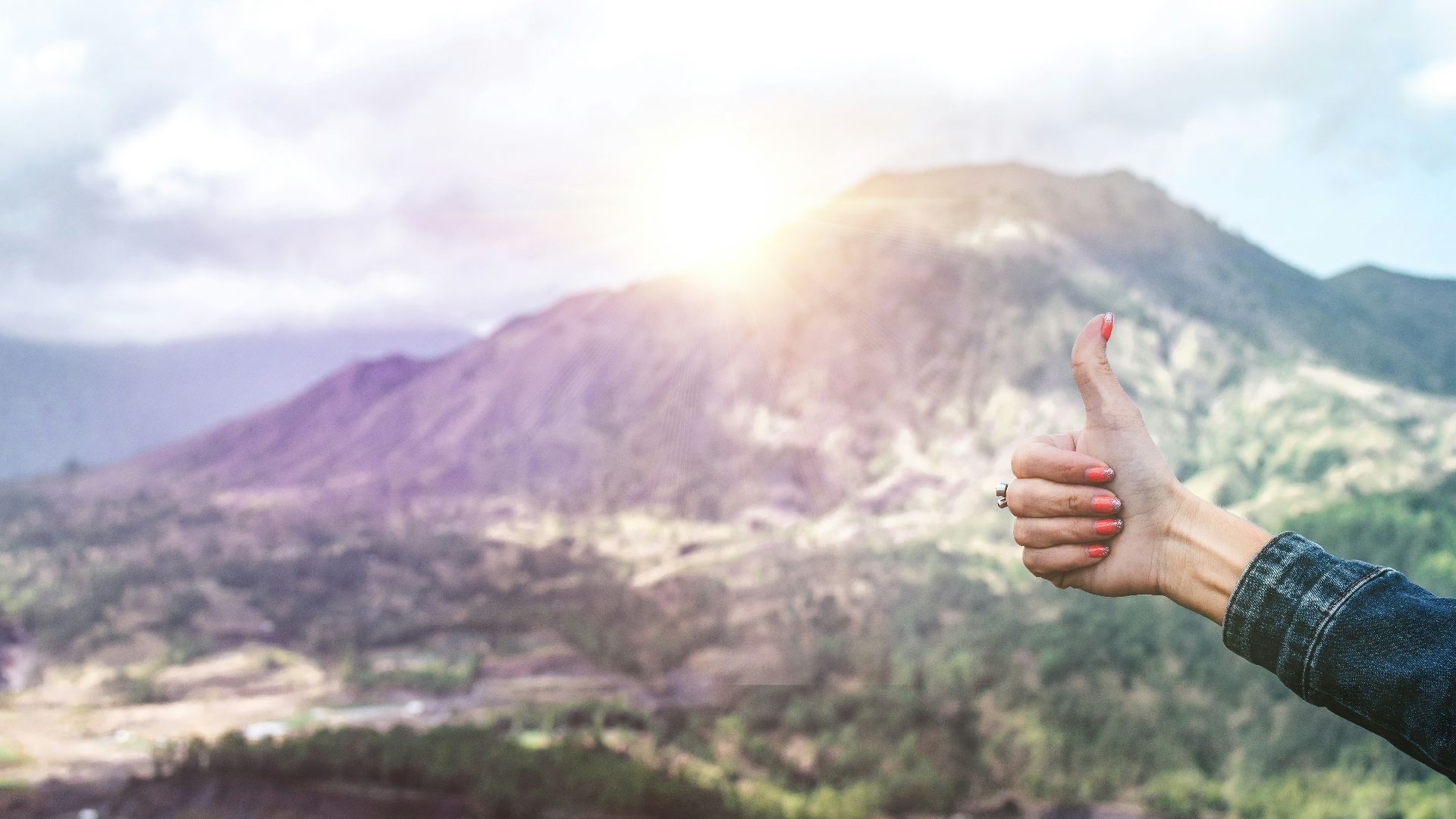 human showing hand on top of mountain