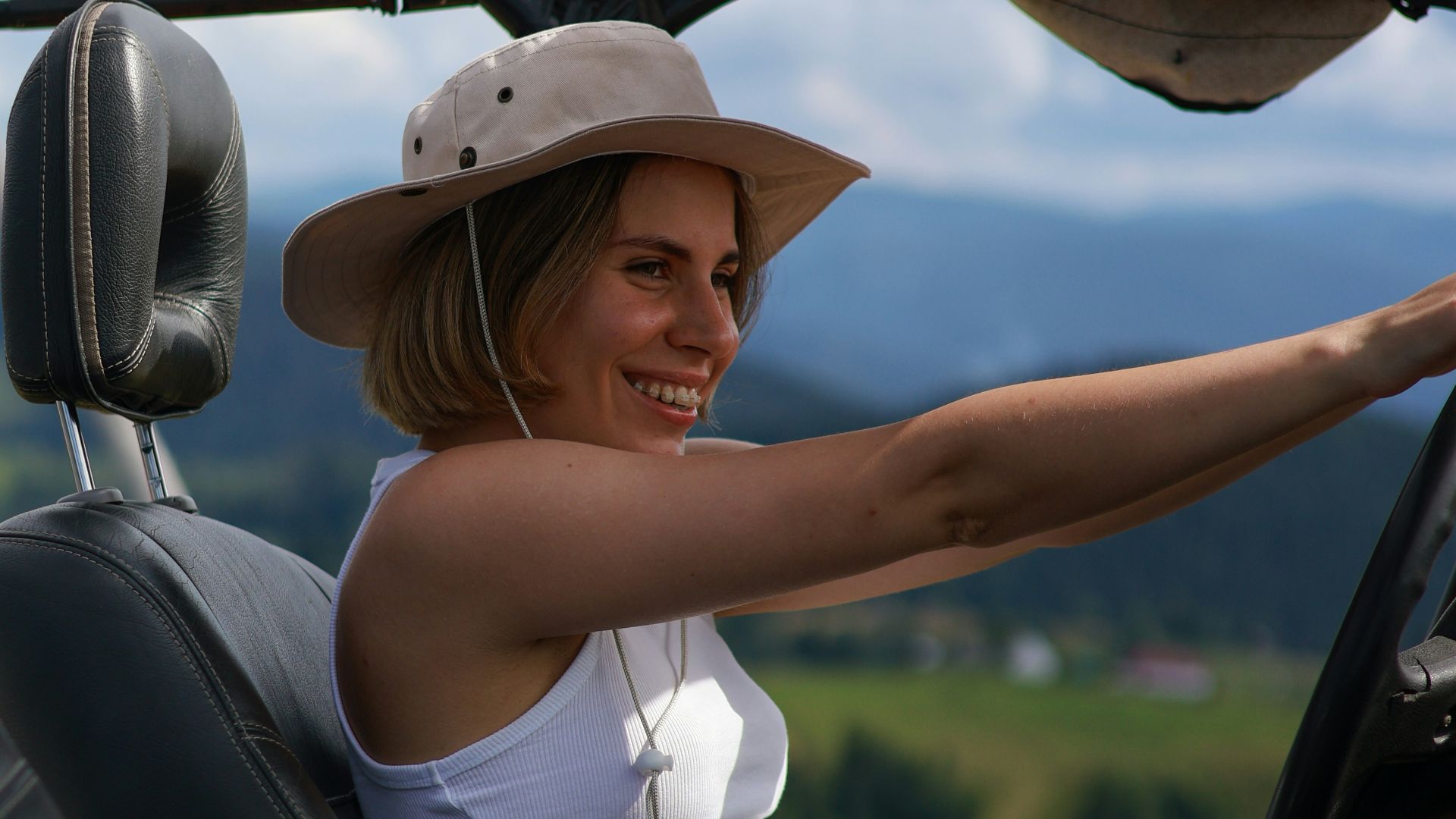 a woman sitting in the driver's seat of a vehicle