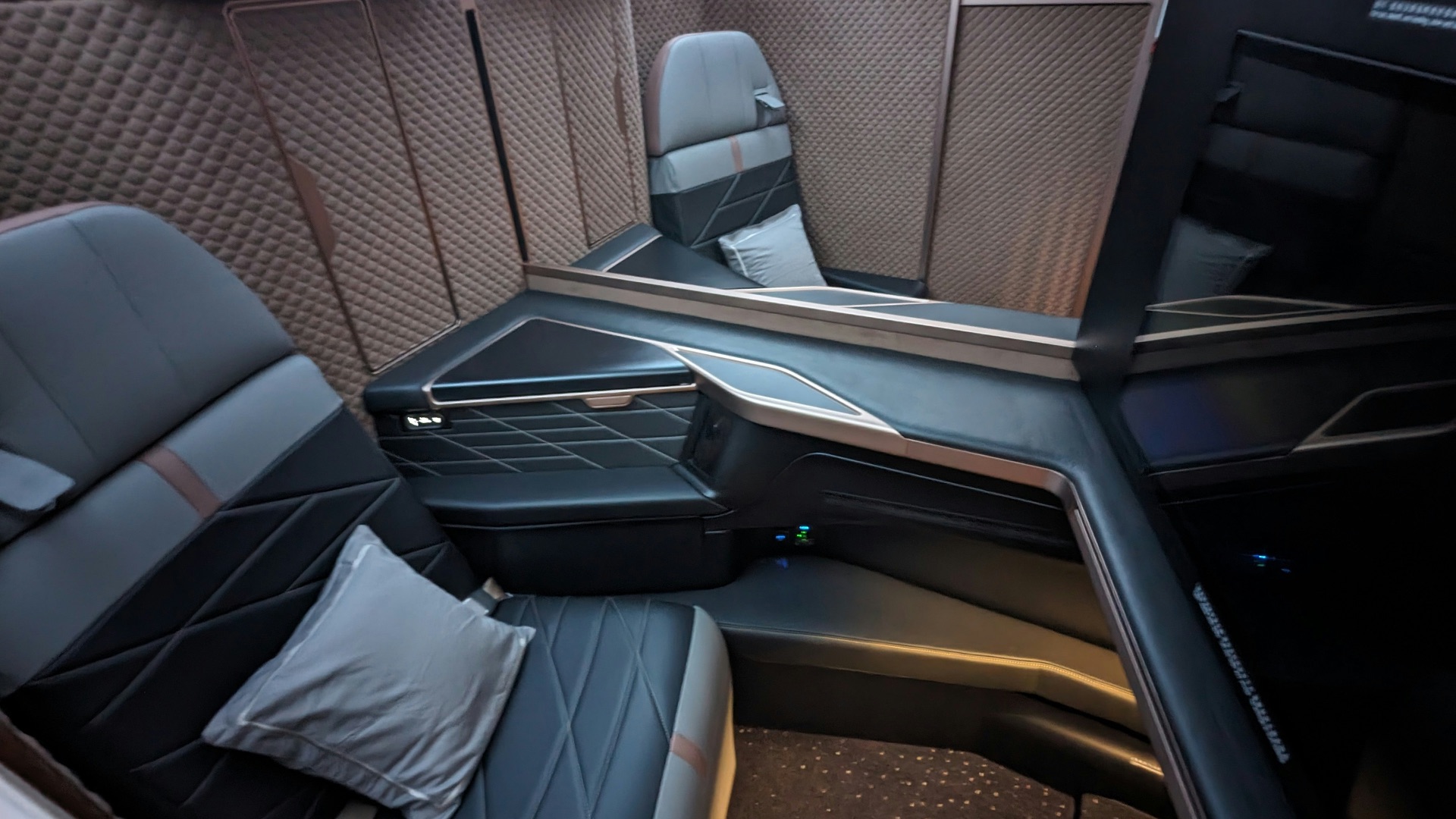 the inside of an airplane with seats and a television