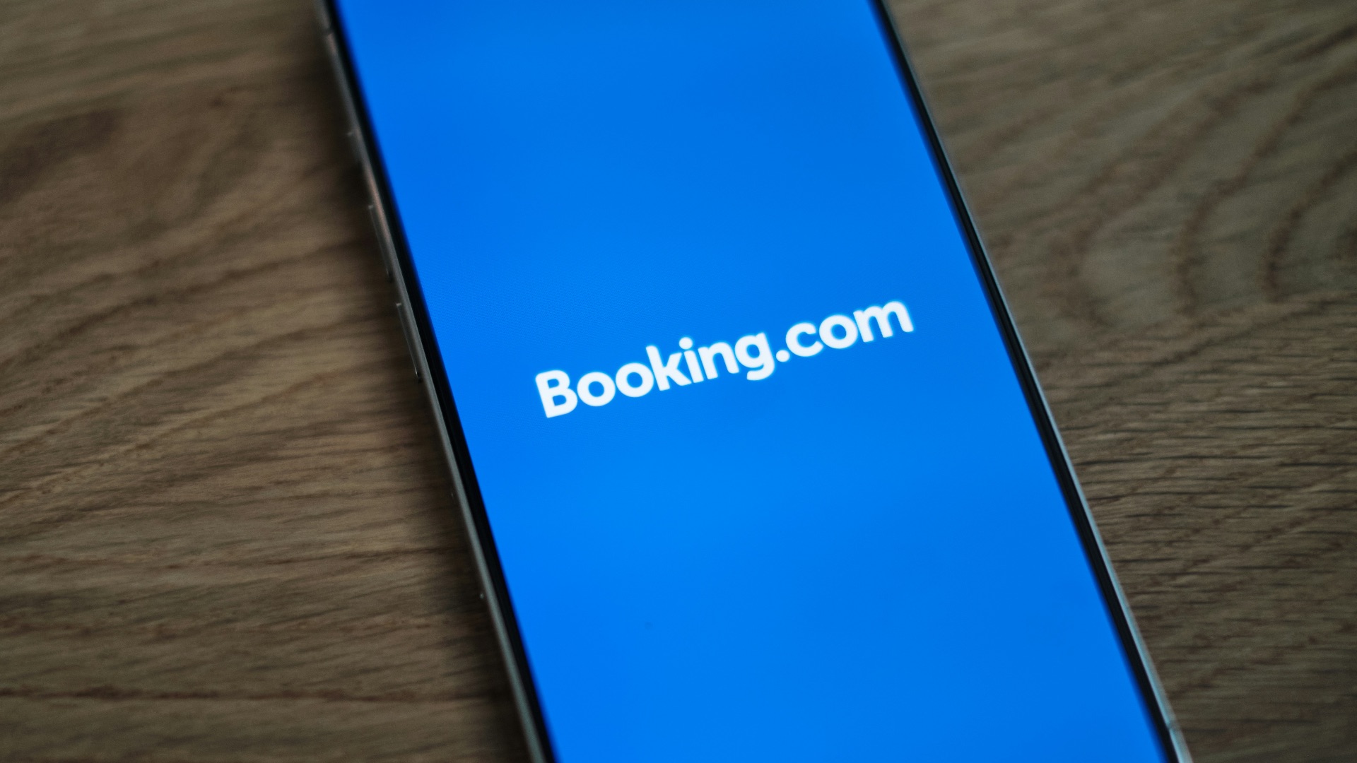 A blue samsung phone with the logo of bookking com on it