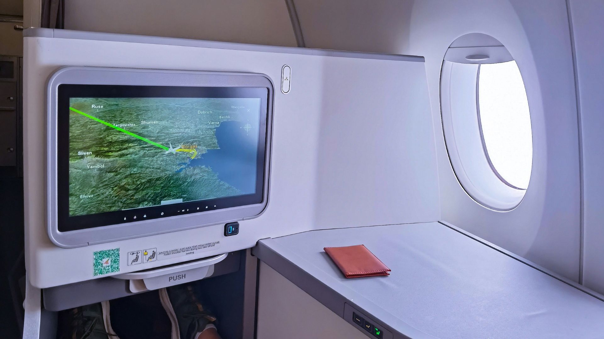 a person's feet on an airplane seat