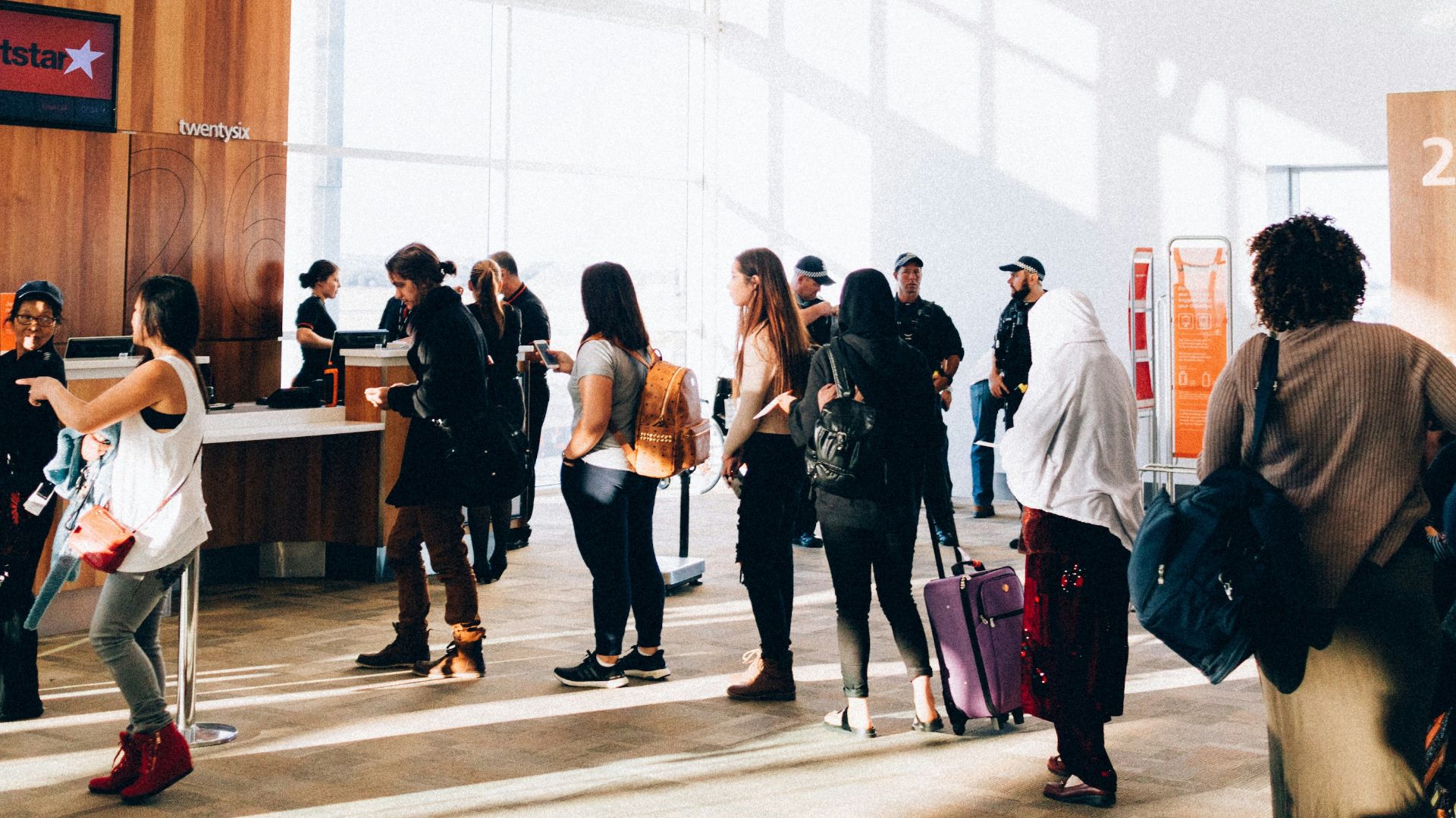 a group of people standing in a large room