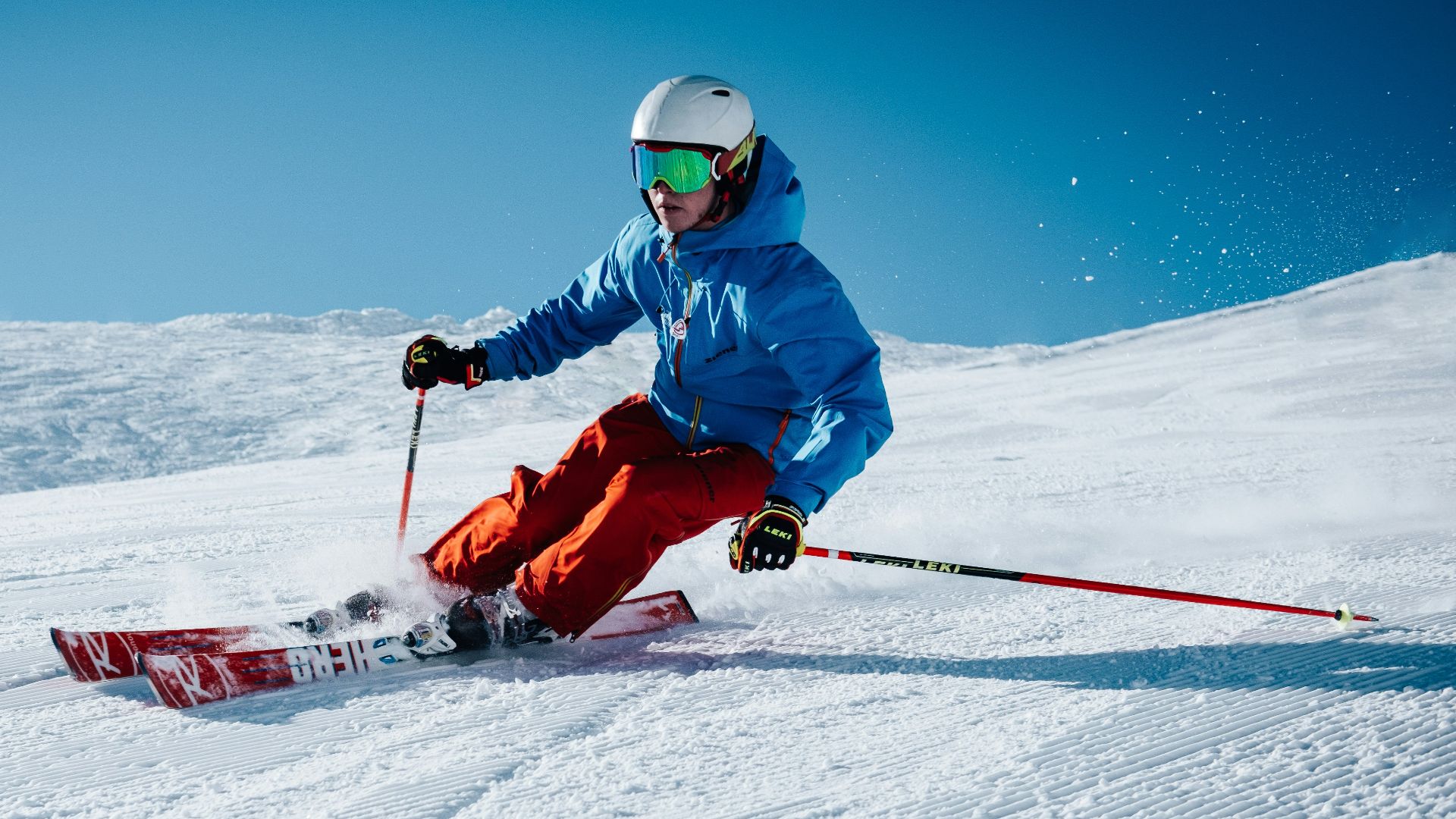 man ice skiing on hill