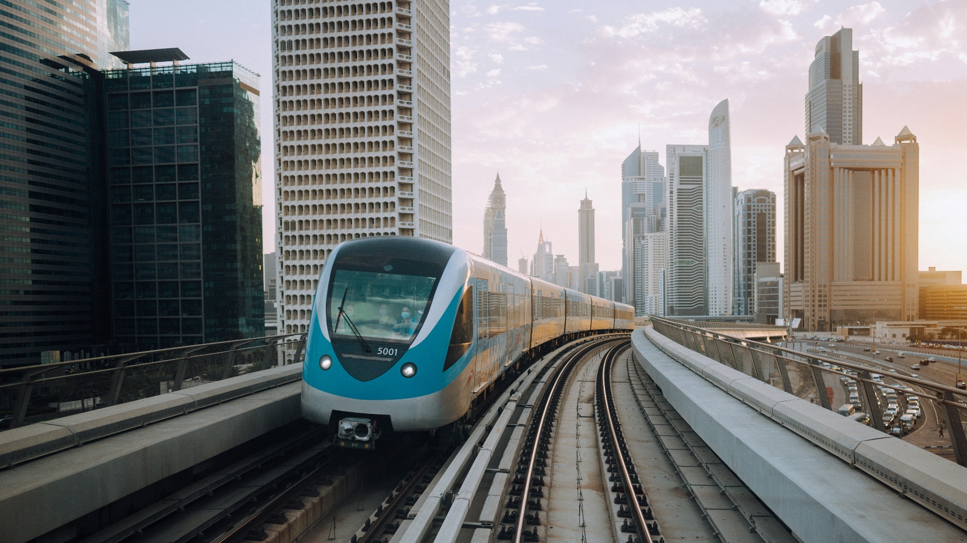 blue and white train on rail road during daytime