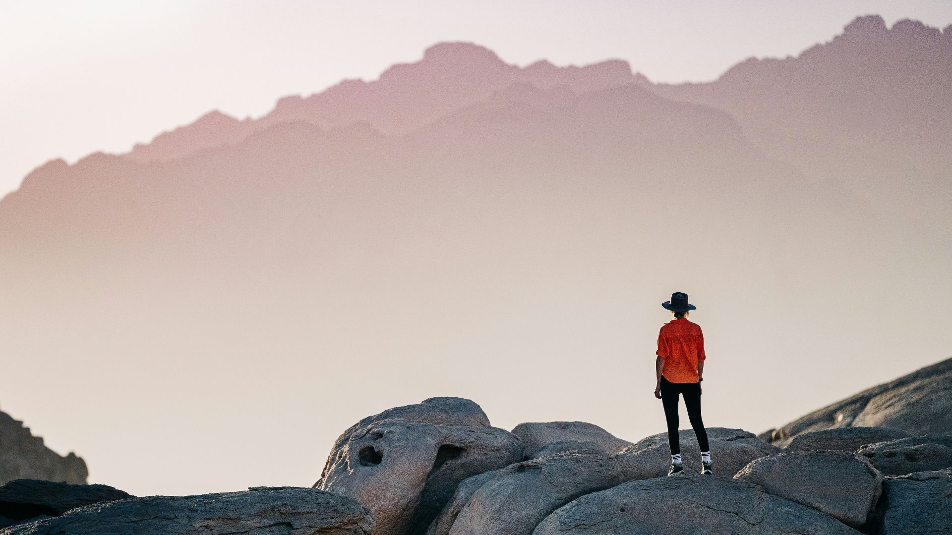 a person standing on top of a large rock
