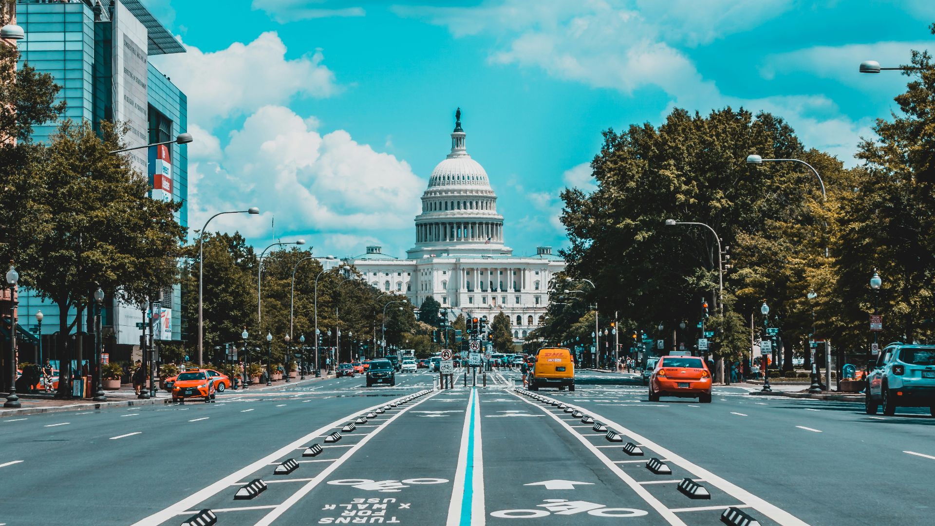 wide road with vehicle traveling with white dome building
