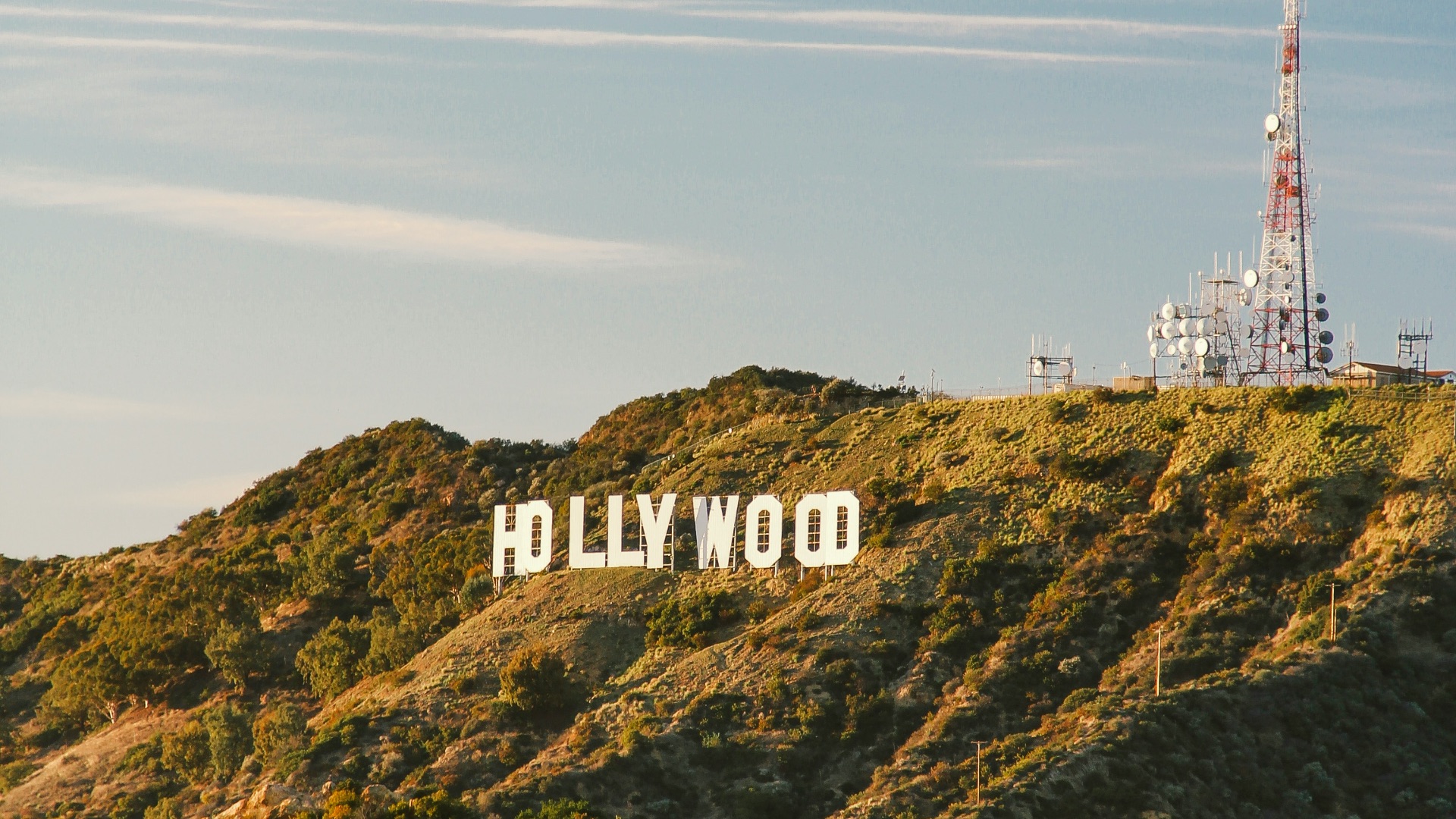 white and red tower on top of green mountain