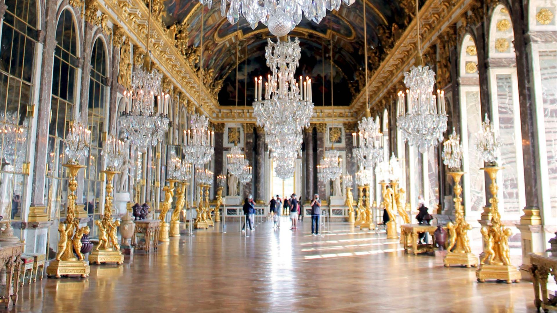 a chandelier hanging from the ceiling of a palace
