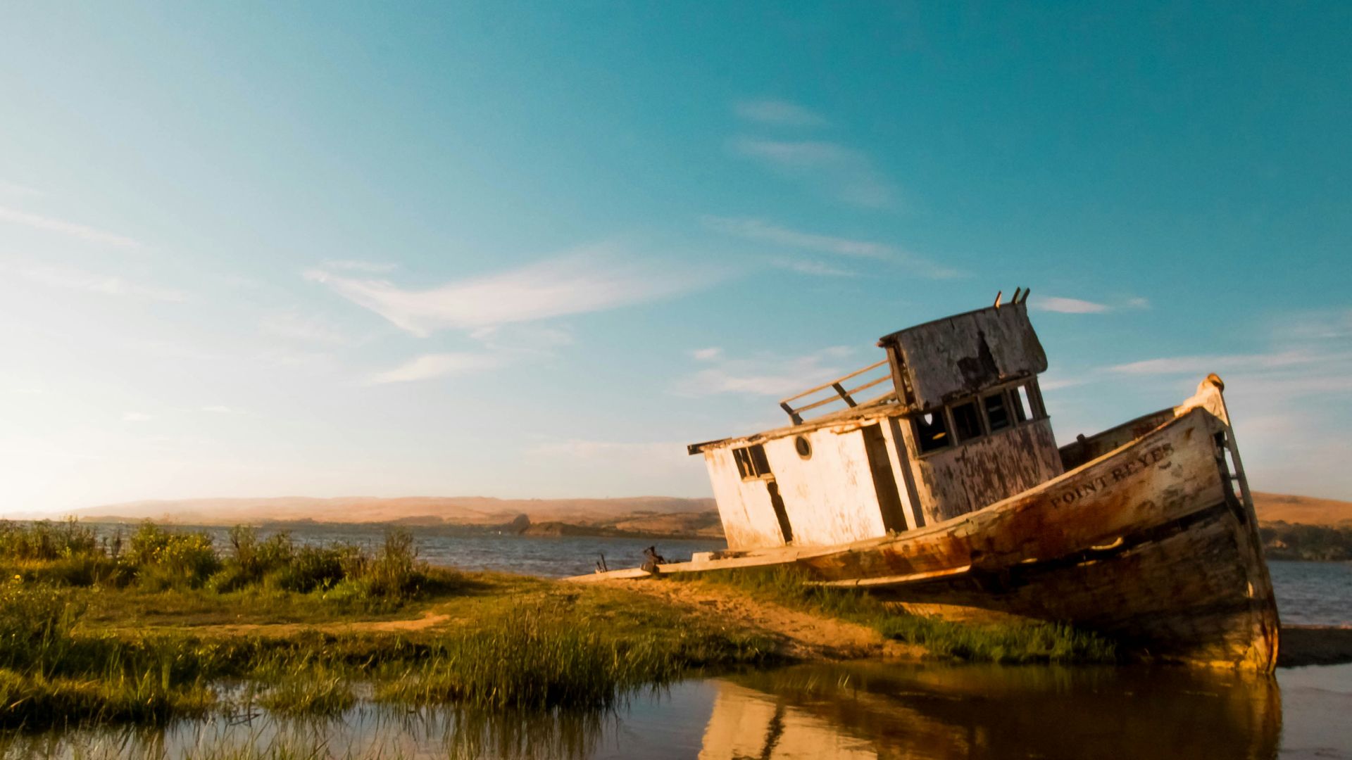 abandoned boat on body of water
