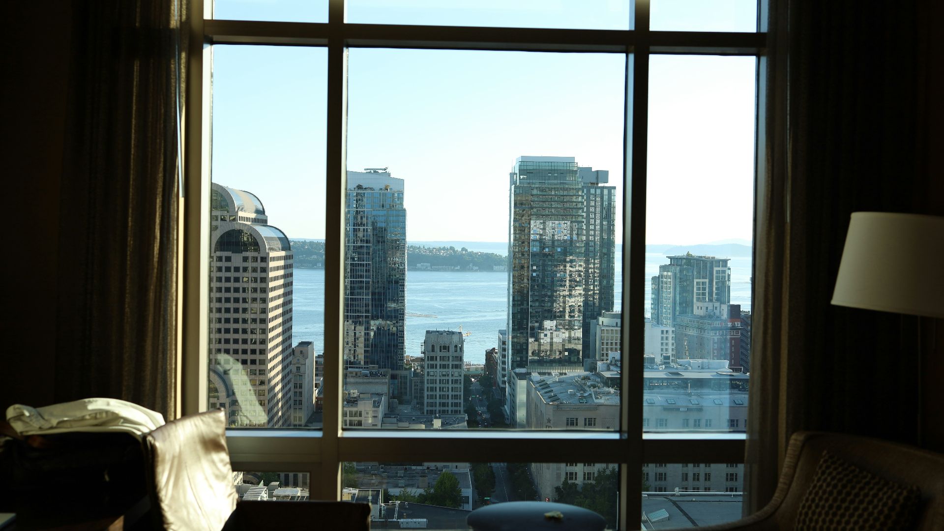 a living room with a large window overlooking a city