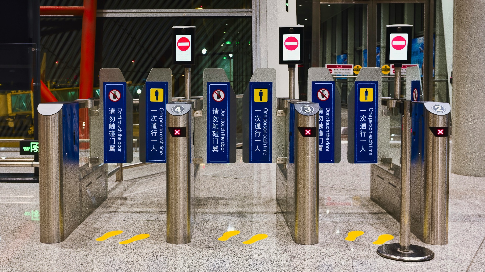 Automated security gates in a modern building entrance.