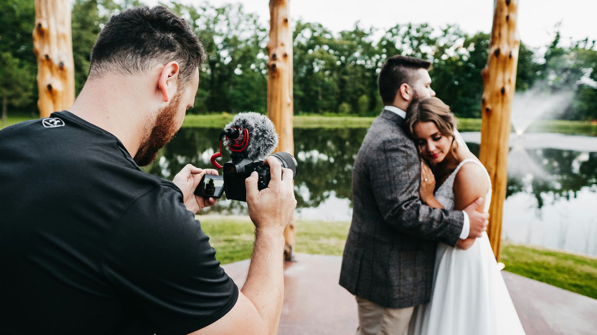 man in black t-shirt holding black dslr camera
