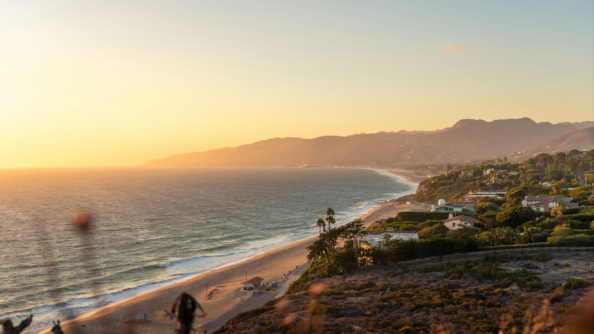 a view of a beach and a city from a hill