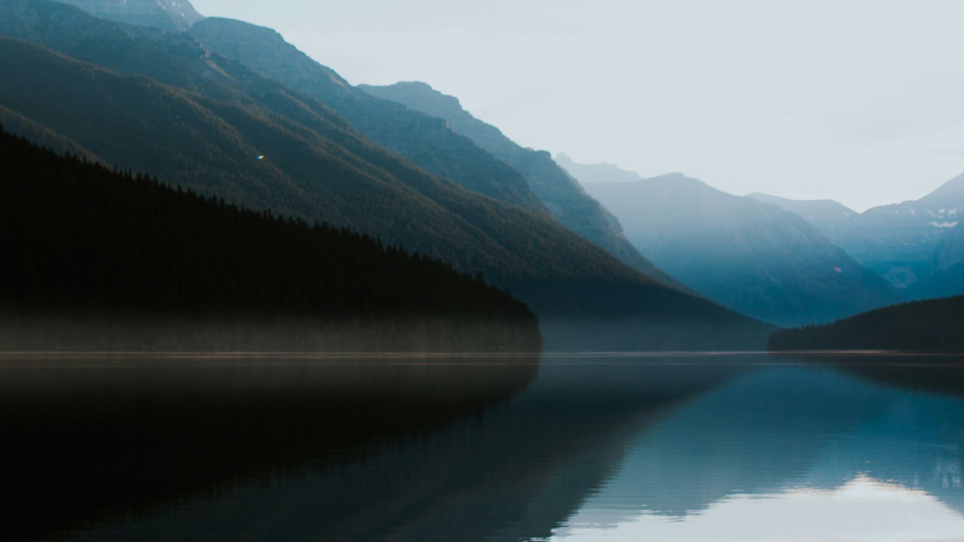 mountains surrounded by body of water