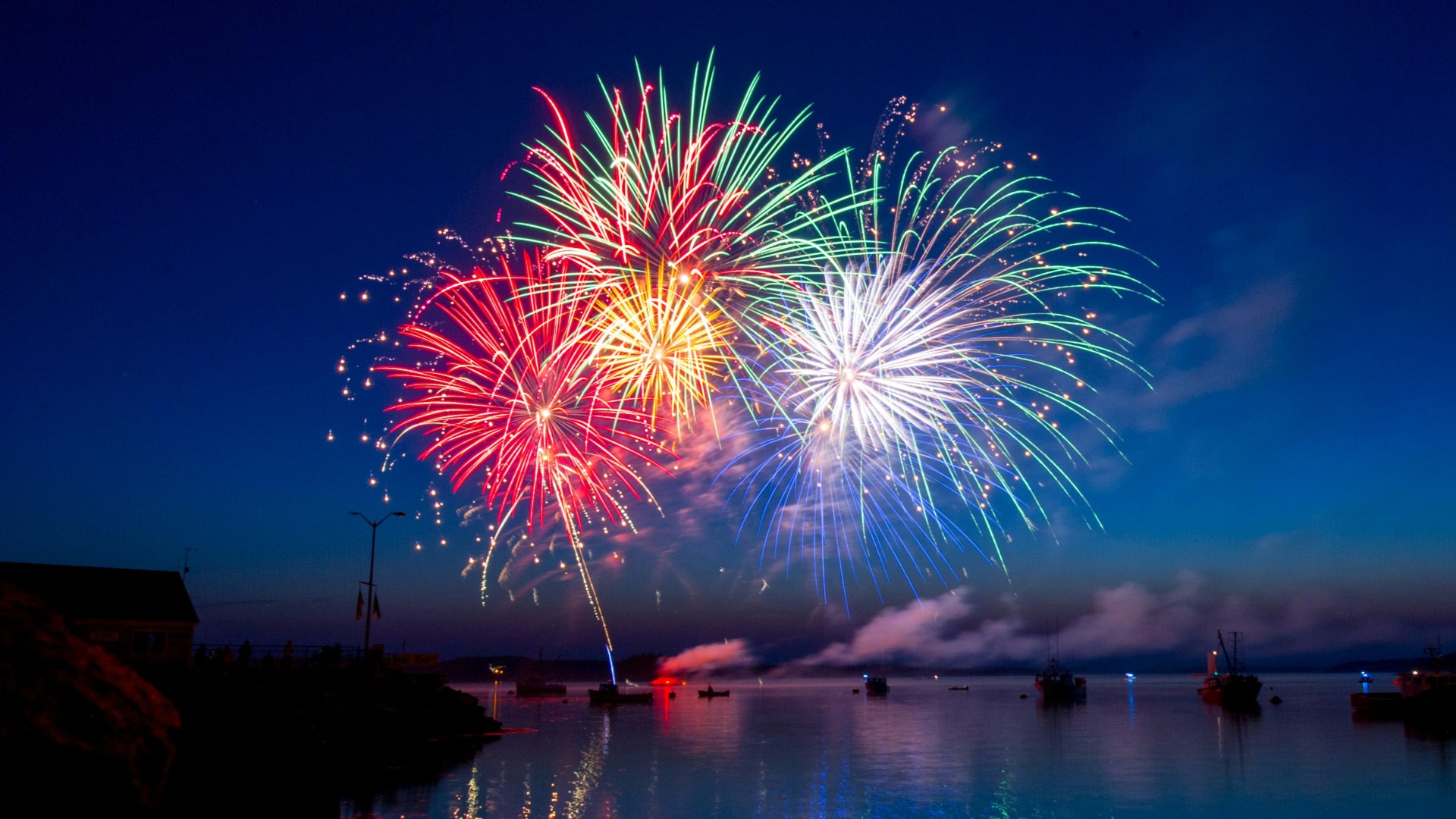 green, red, and white fireworks on sky at nighttime